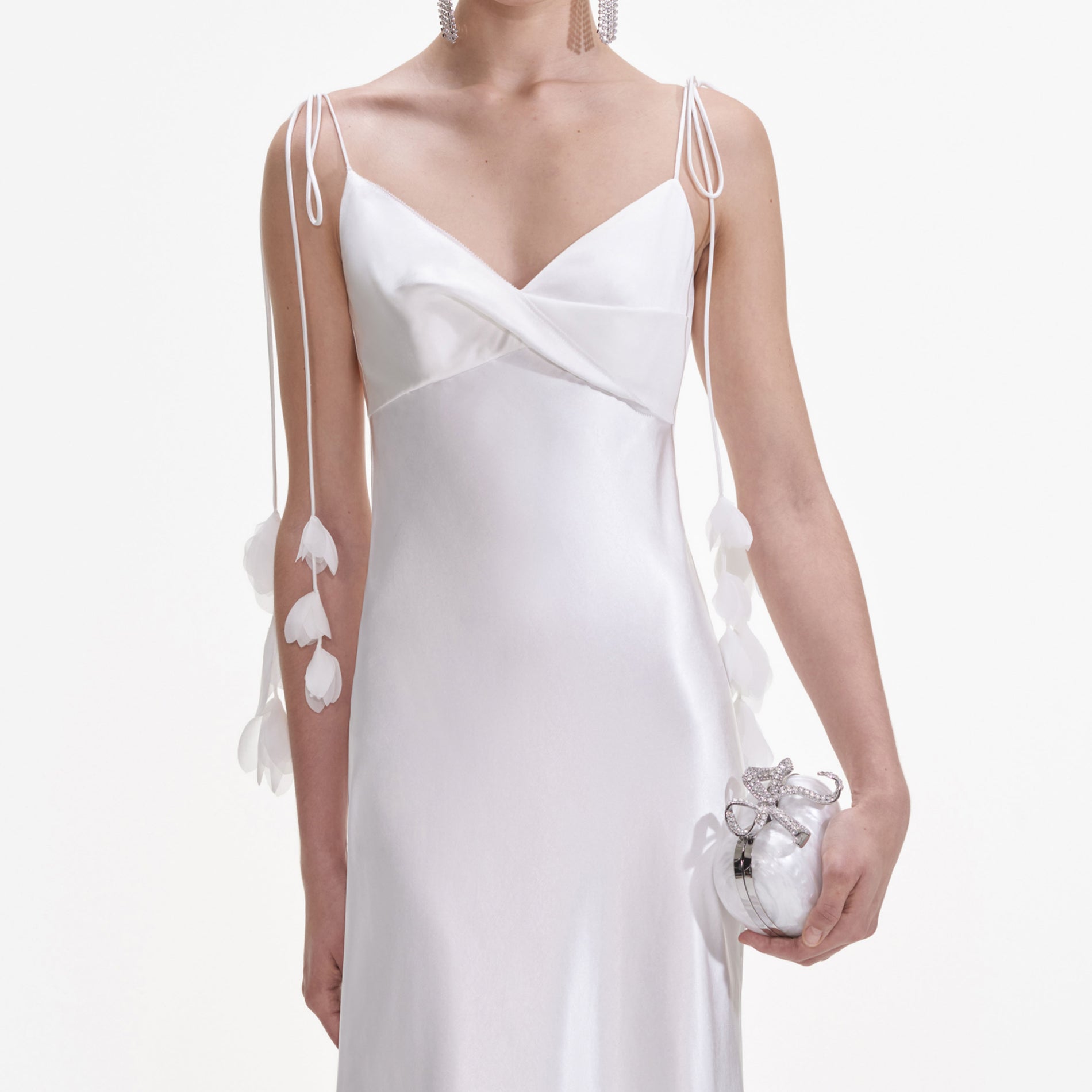 A close up of a woman wearing the White Satin Flower Midi Dress