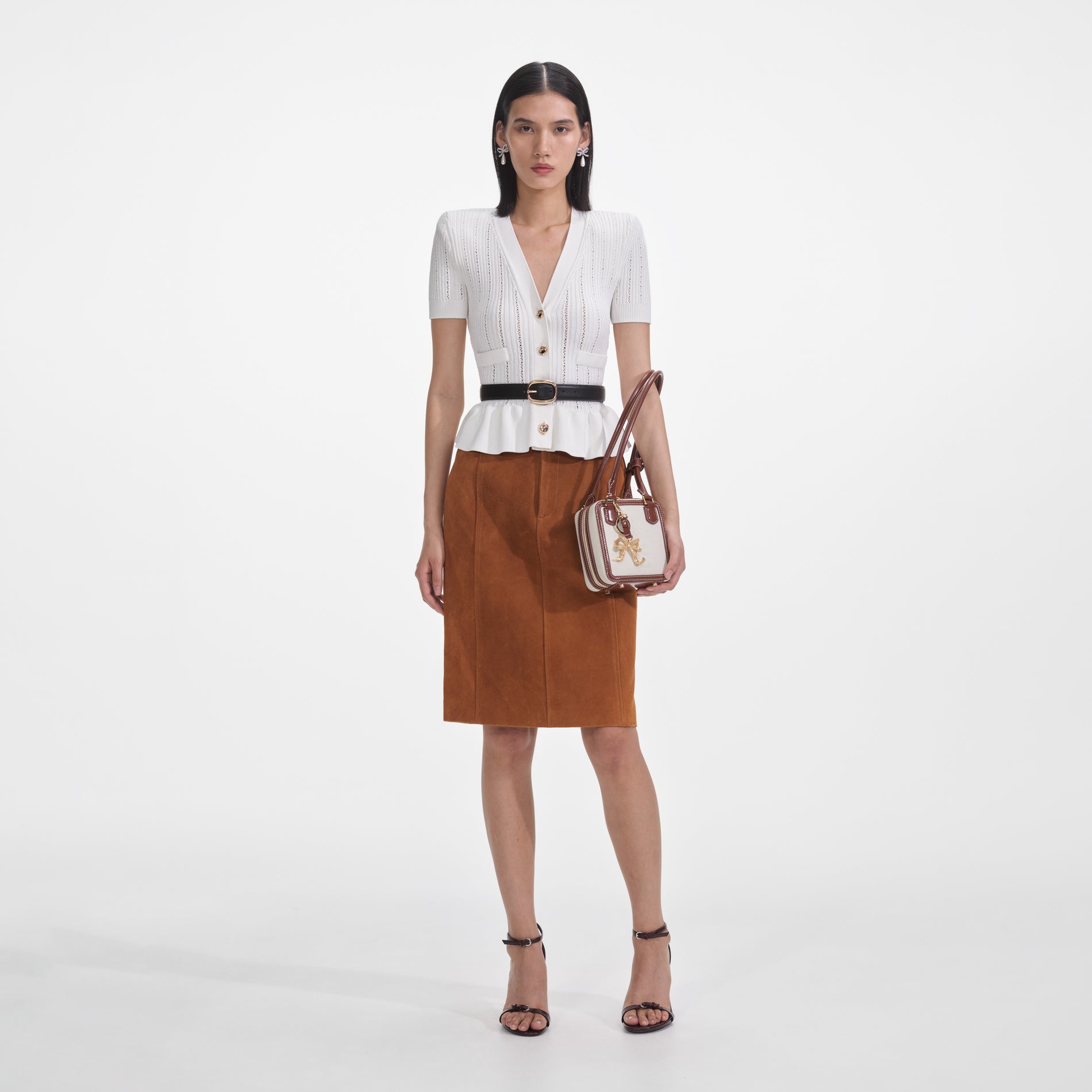 Front view of a woman wearing the White Peplum Knit Top