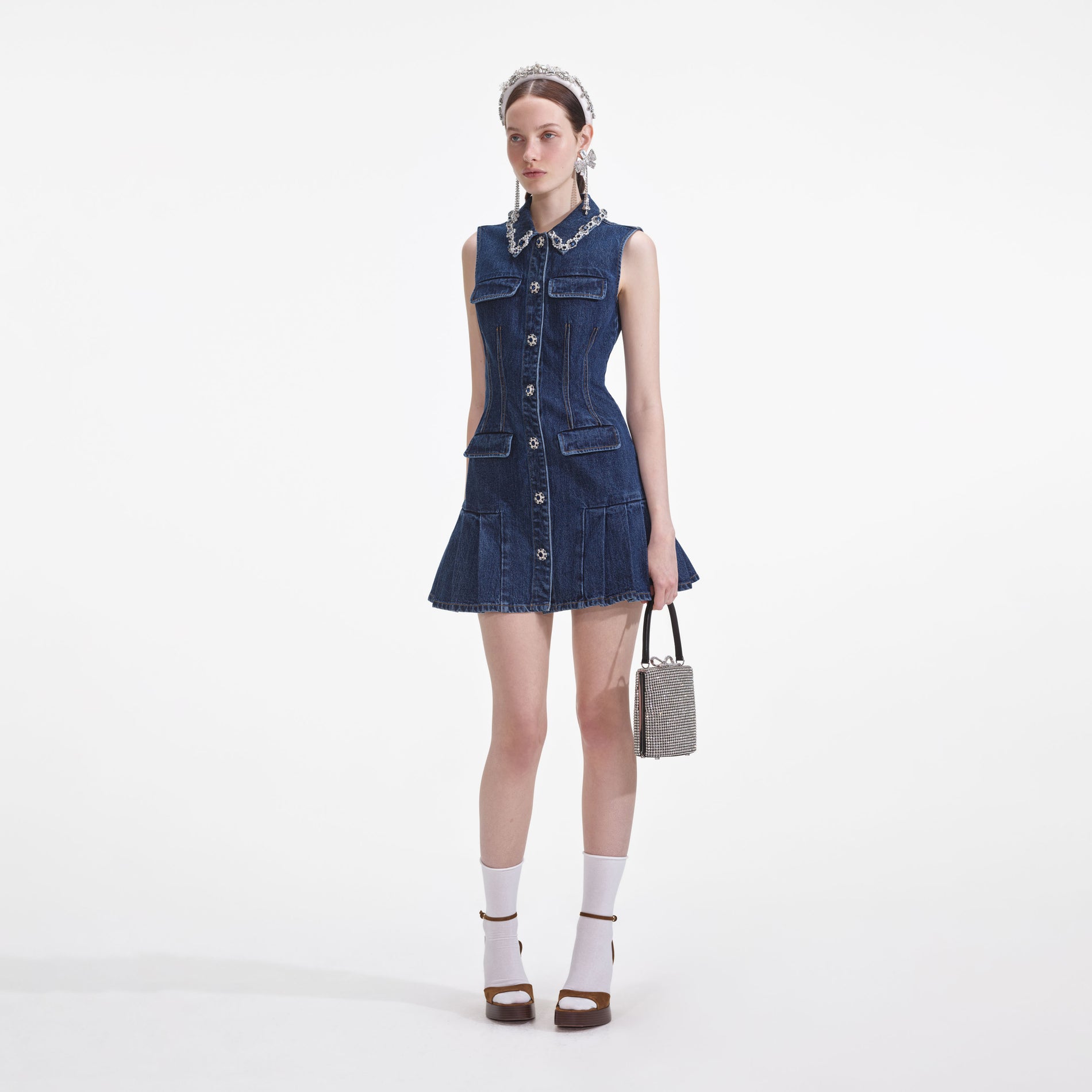 Side view of a woman wearing the Denim Sleeveless Mini Dress