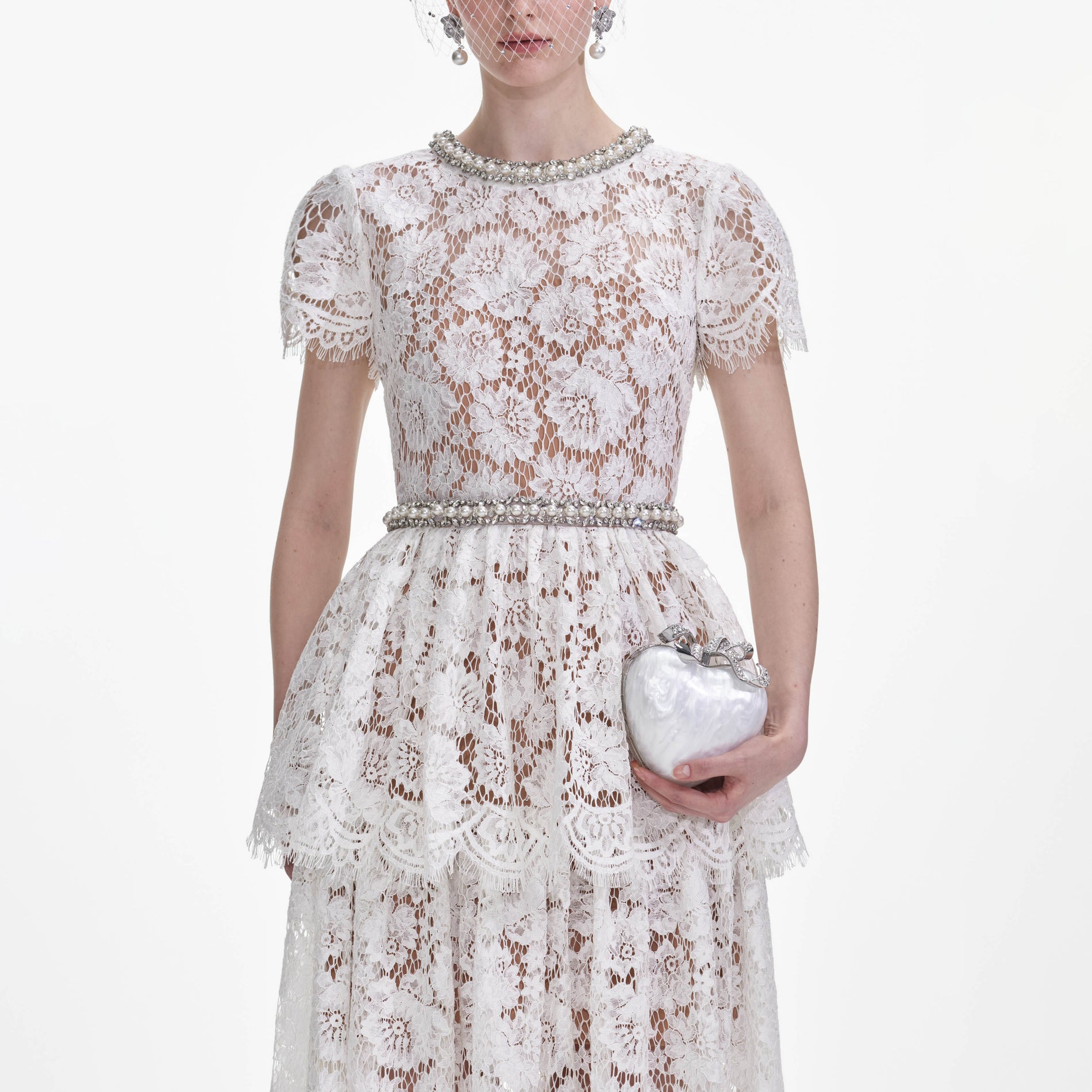 A close up of a woman wearing the White Lace Tiered Maxi Dress