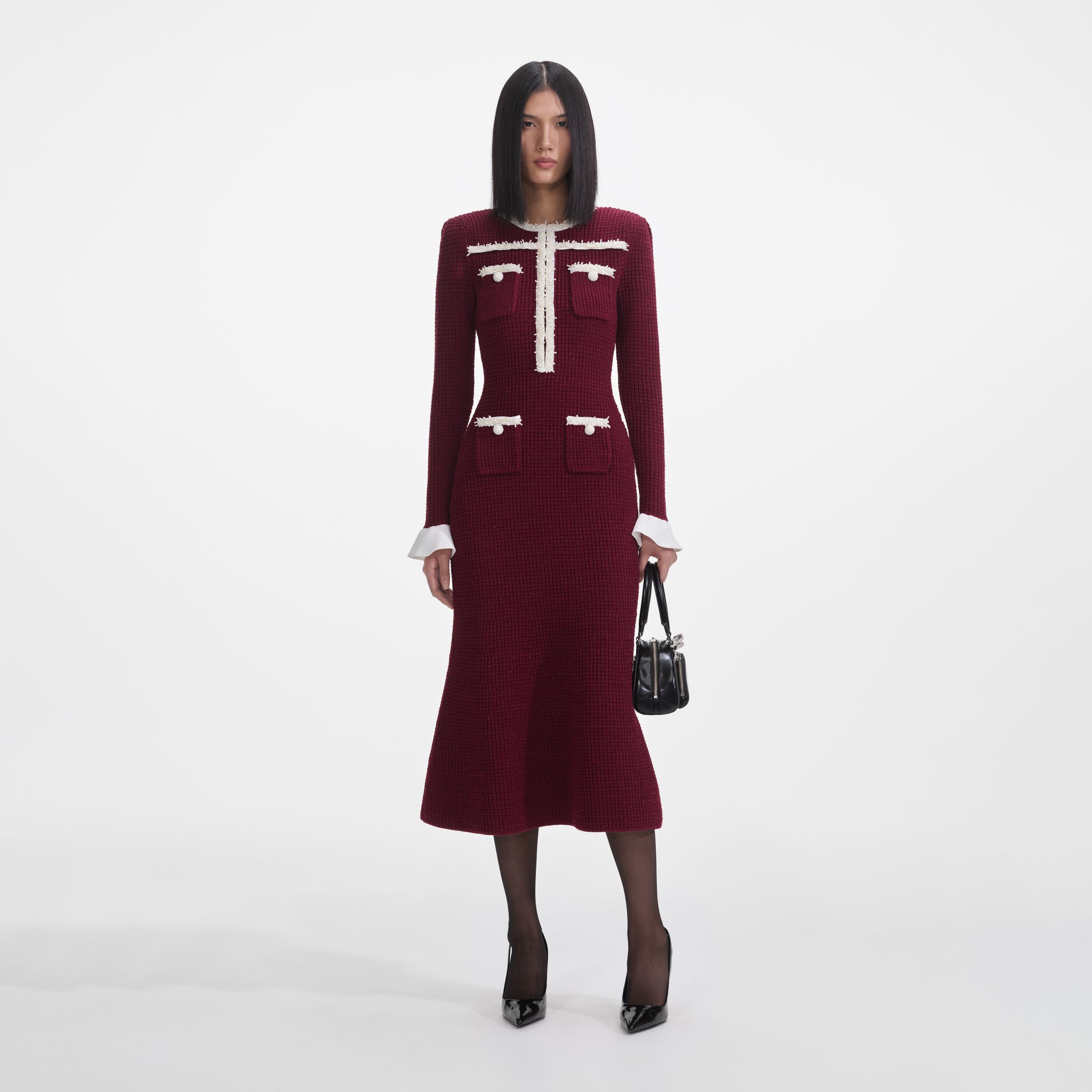 Front view of a woman wearing the Burgundy Pearl Trim Knit Midi Dress