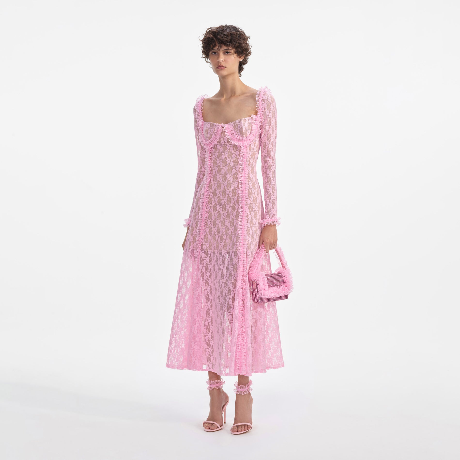 Side view of a woman wearing the Pink Lace Ruffle Midi Dress