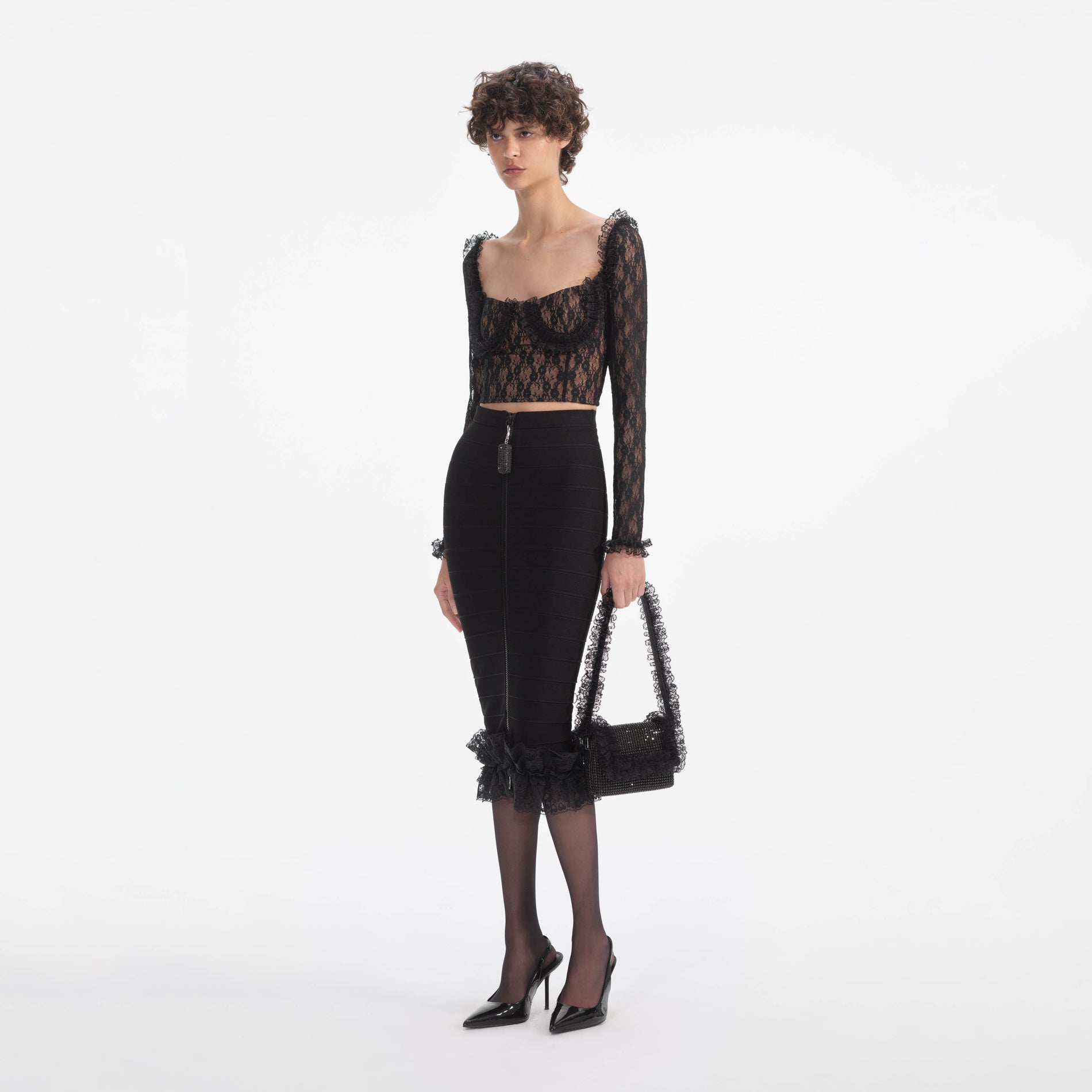 Side view of a woman wearing the Black Lace Ruffle Top