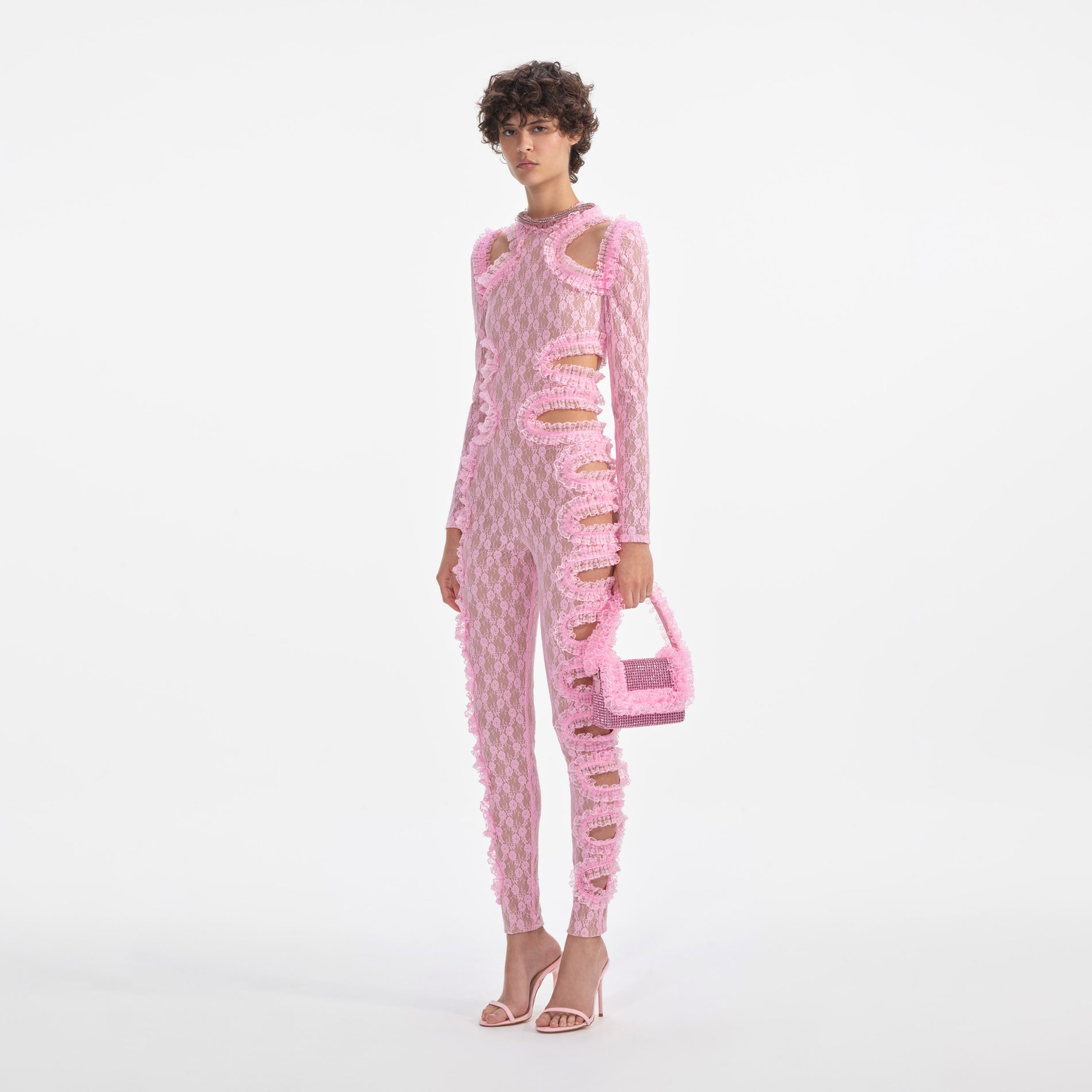 Side view of a woman wearing the Pink Lace Cut Out Jumpsuit