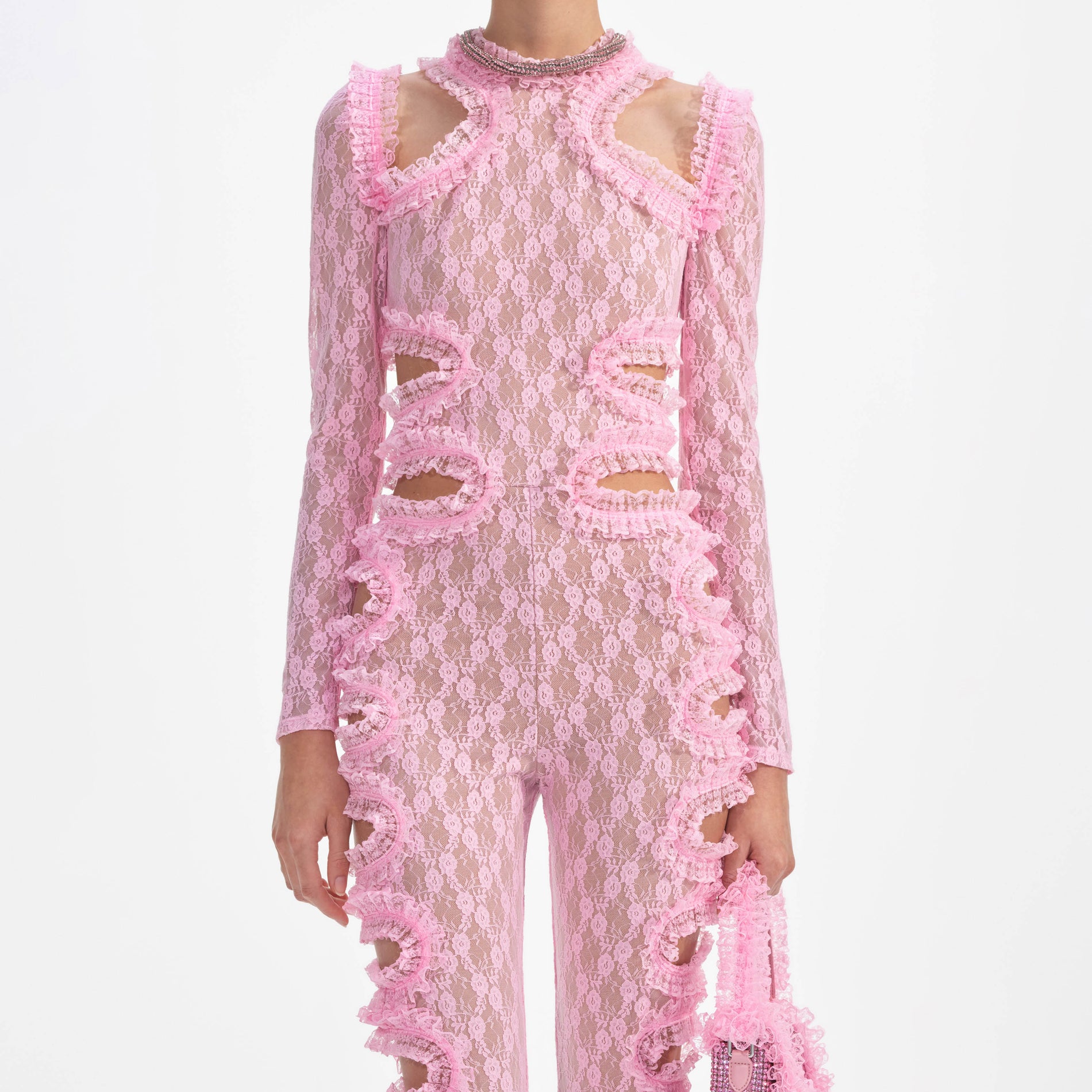 A close up of a woman wearing the Pink Lace Cut Out Jumpsuit
