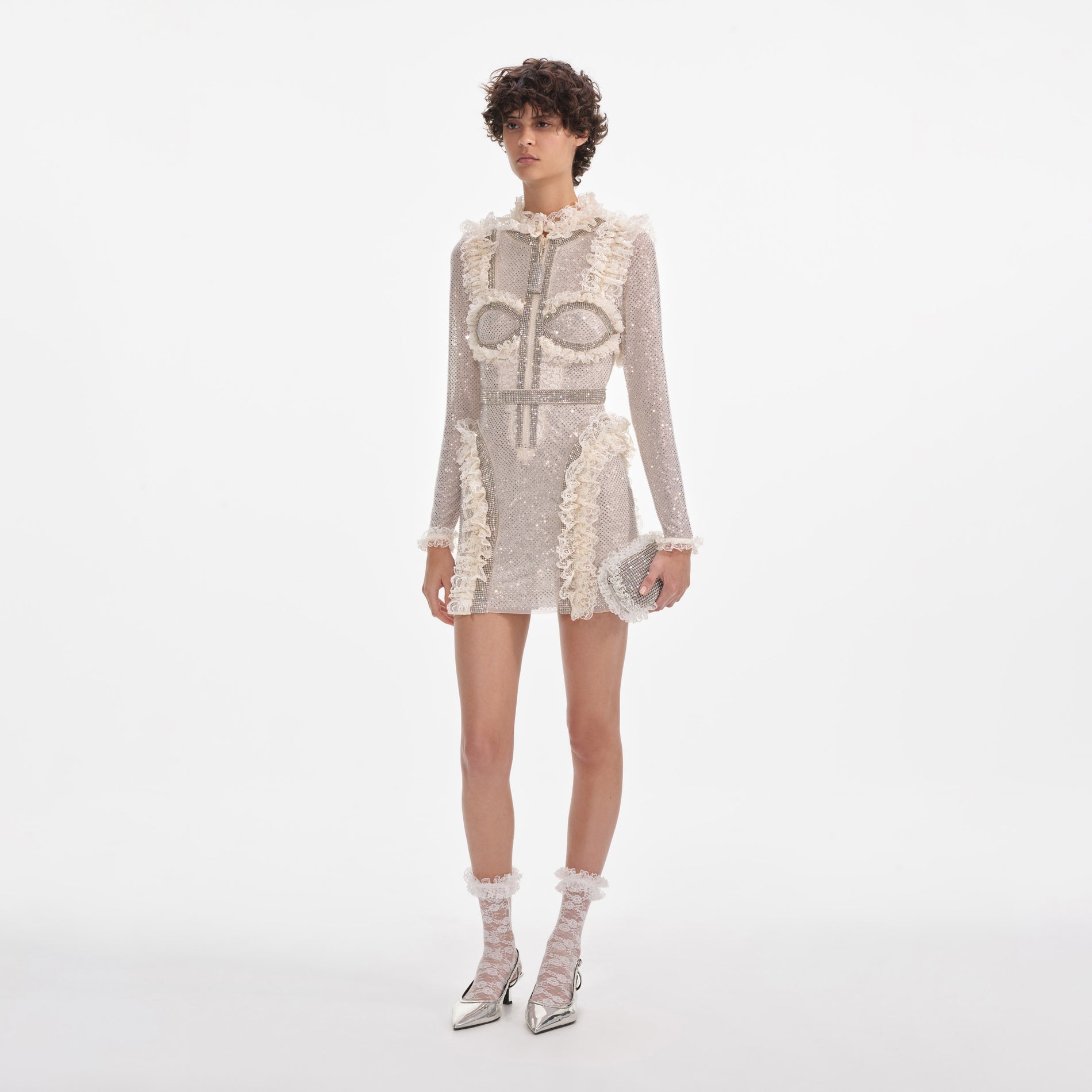 Side view of a woman wearing the Cream Rhinestone Mesh Ruffle Mini Dress