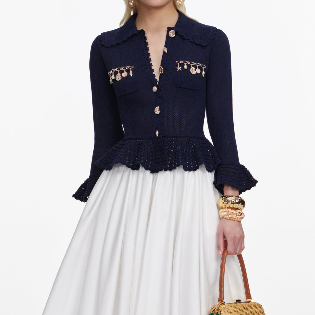 A close up of a woman wearing the Navy Shell Embellished Cardigan