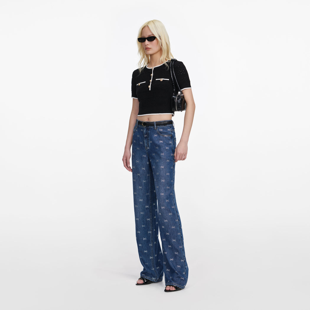 Side view of a woman wearing the Black Pointelle Knit Top
