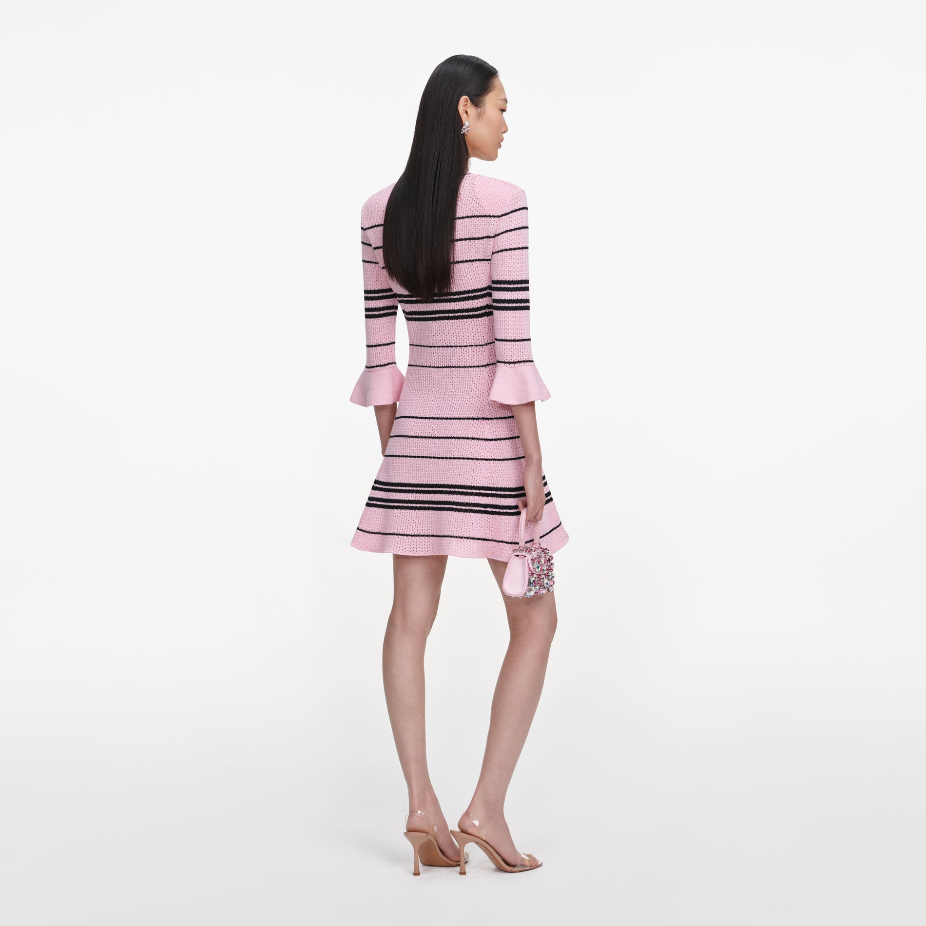 Back view of a woman wearing the Pink Stripe Knit Mini Dress