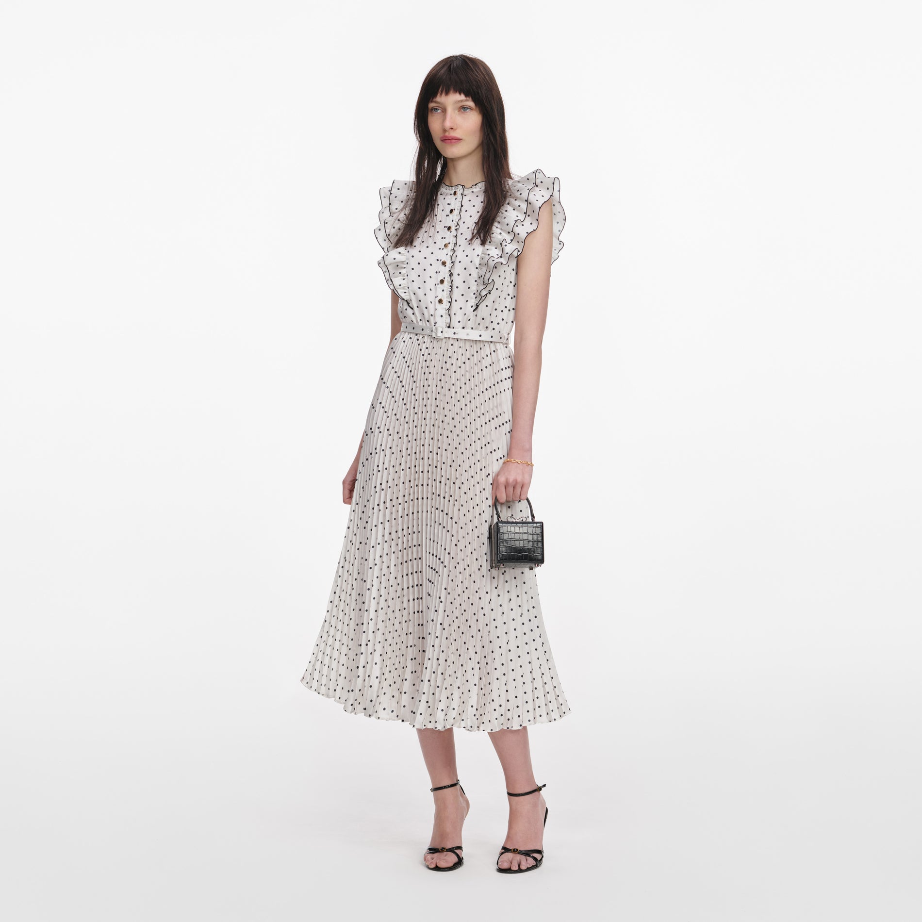 Side view of a woman wearing the Cream Ramie Polka Dot Midi Dress