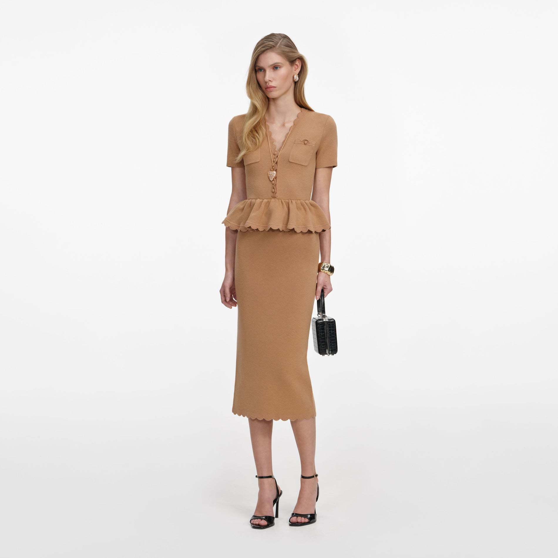 Side view of a woman wearing the Camel Knit Peplum Midi Dress