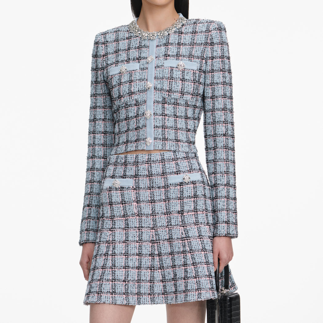 A close up of a woman wearing the Blue Check Knit Mini Skirt