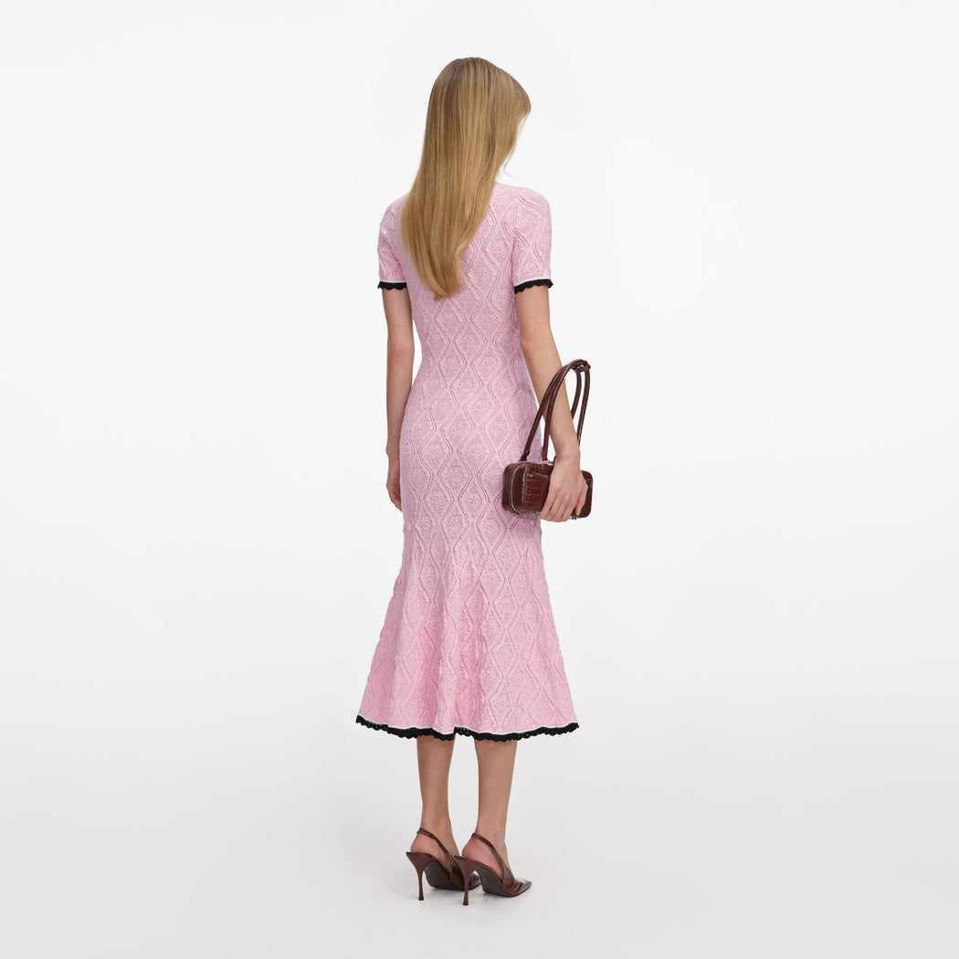 Back view of a woman wearing the Pink Pointelle Knit Midi Dress