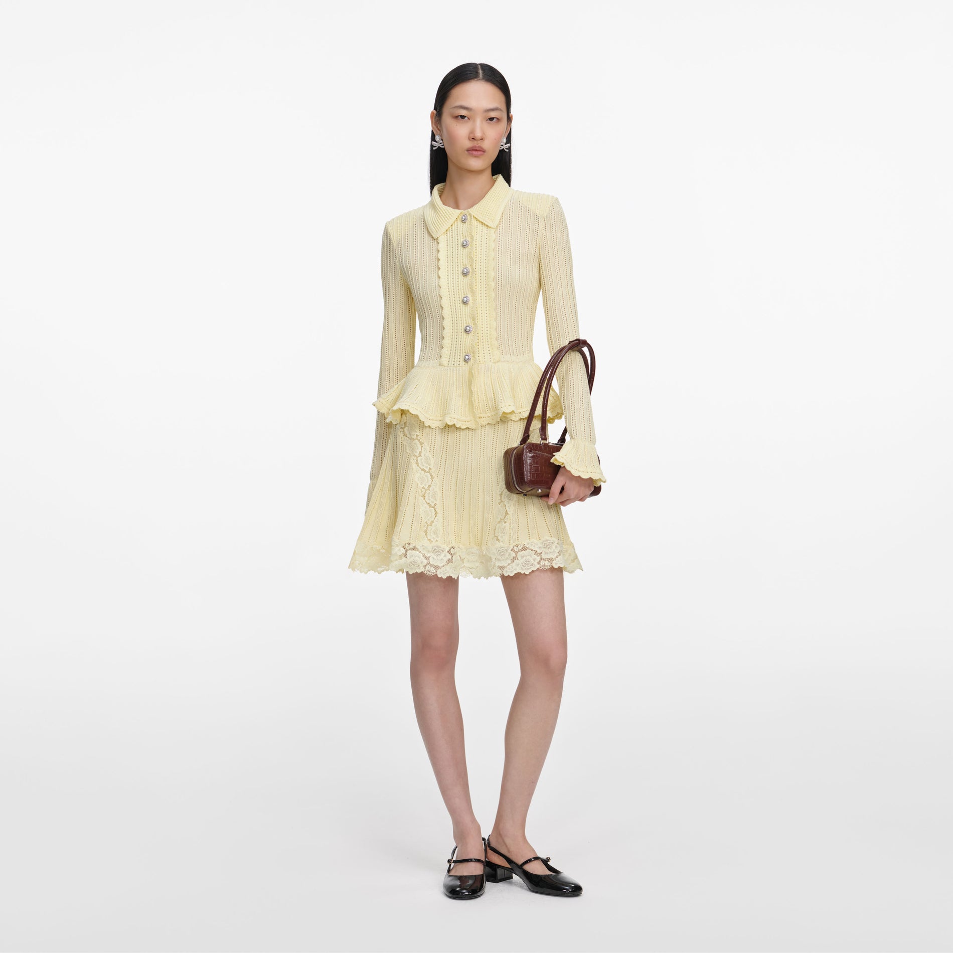 Front view of a woman wearing the Yellow Pointelle Peplum Knit Mini Dress