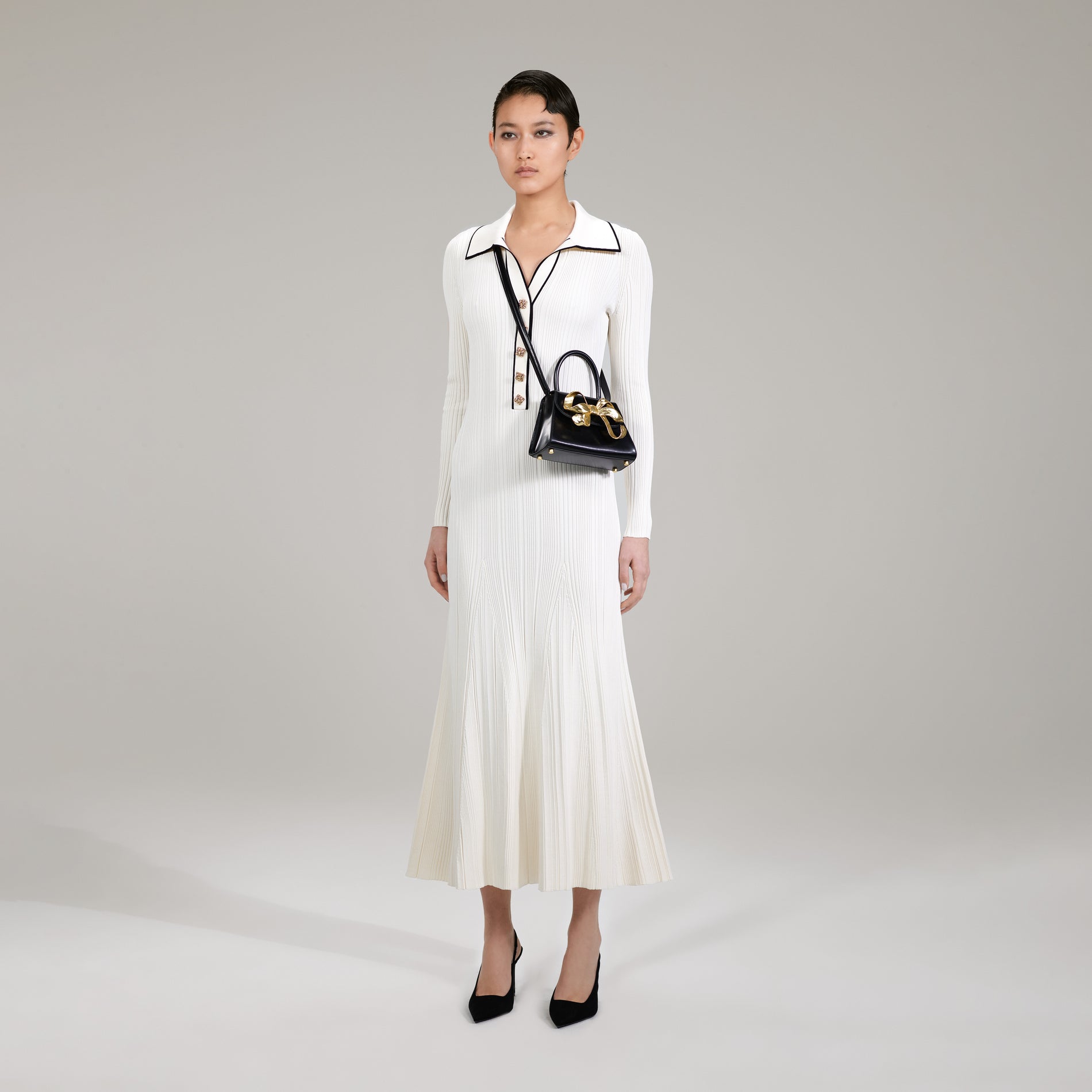 A woman wearing the Ivory Contrast Stitch Knit Dress