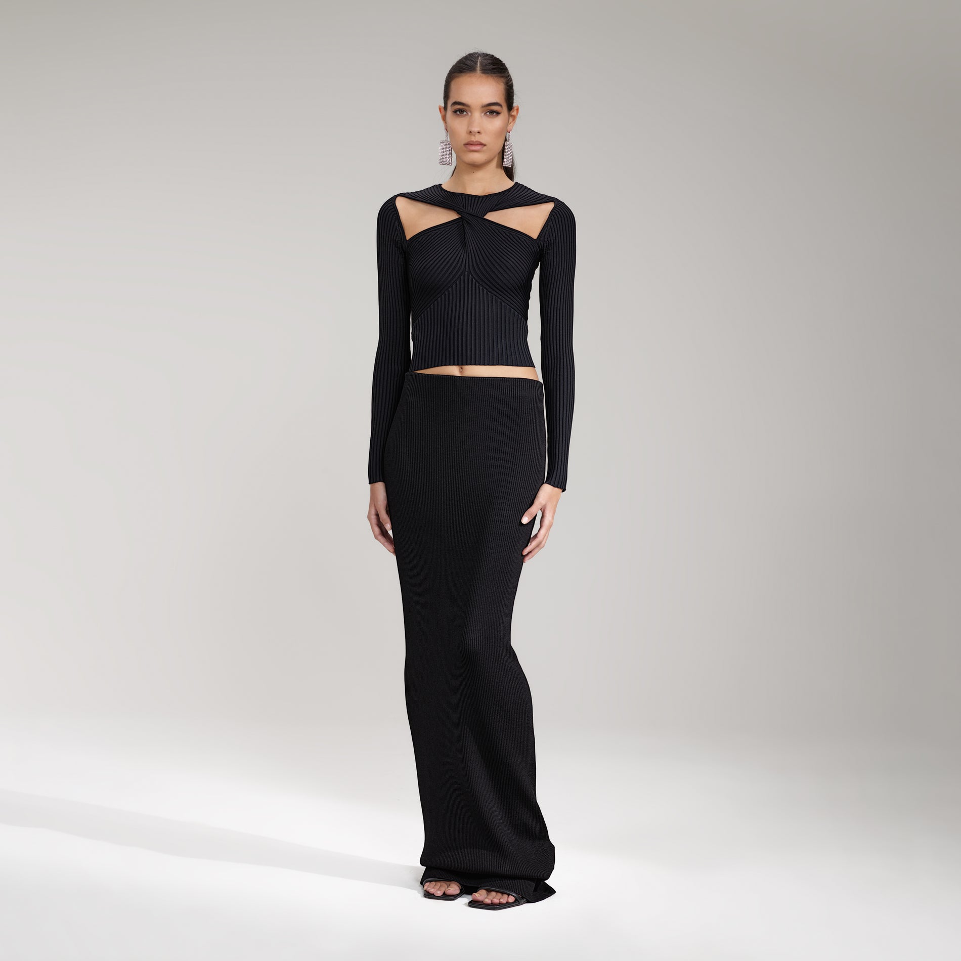 A woman wearing the Black Ribbed Knit Cut Out Top