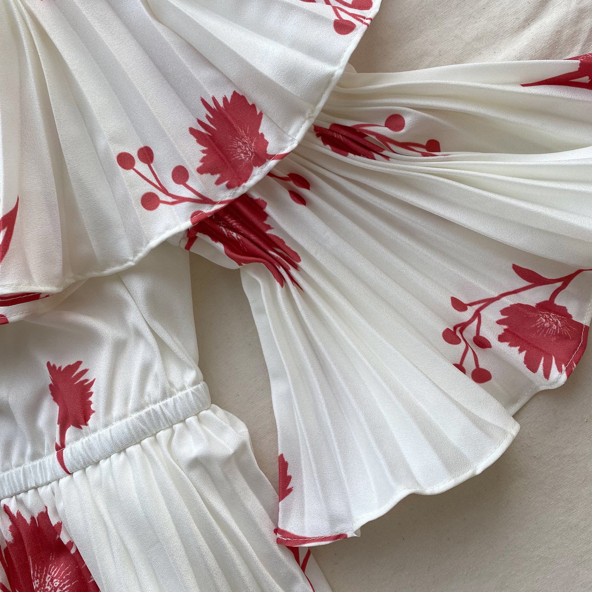 A close up of the fabric for the Wild Daisy Print Pleated Strapless Midi Dress