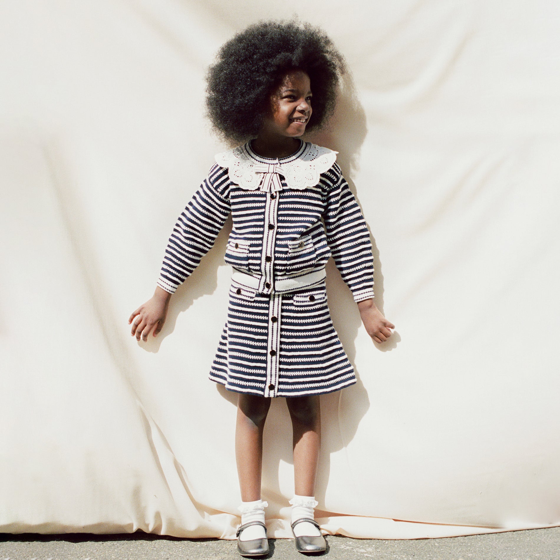 A woman wearing the Navy Contrast Rope Knit Cardigan