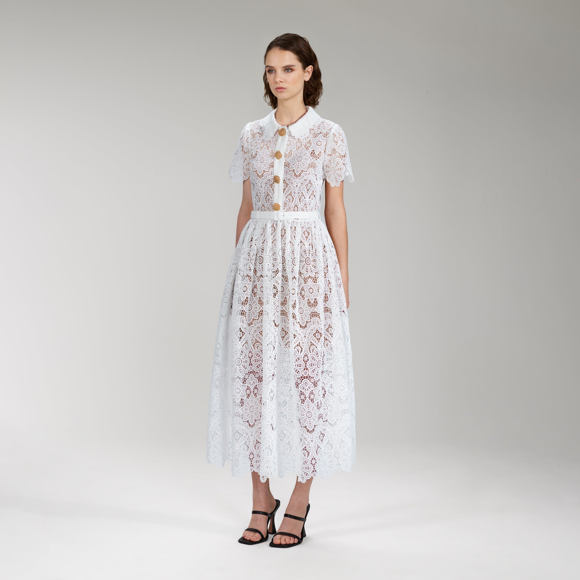 A woman wearing the White Floral Guipure Lace Midi Dress