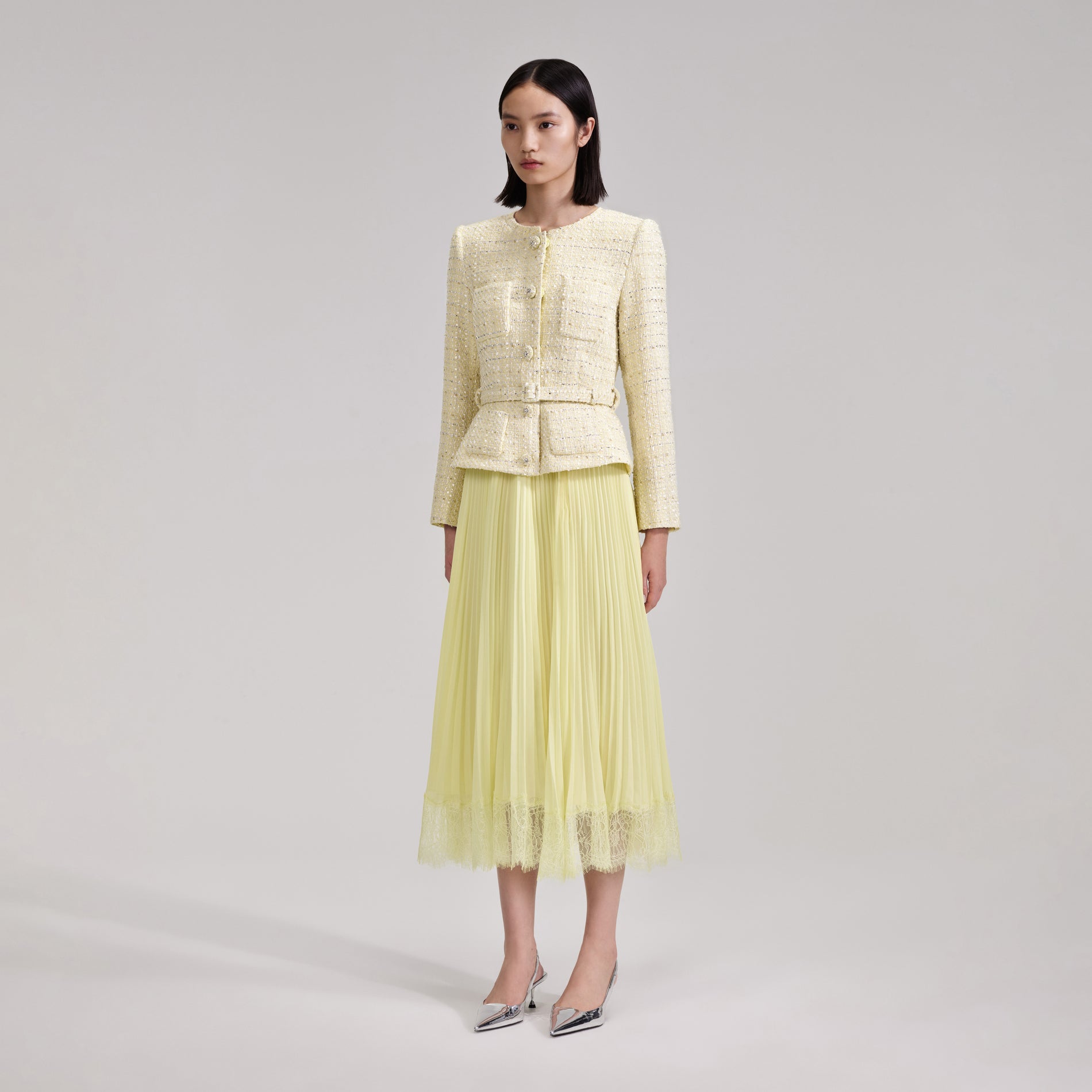 A woman wearing the Yellow Boucle Midi Dress