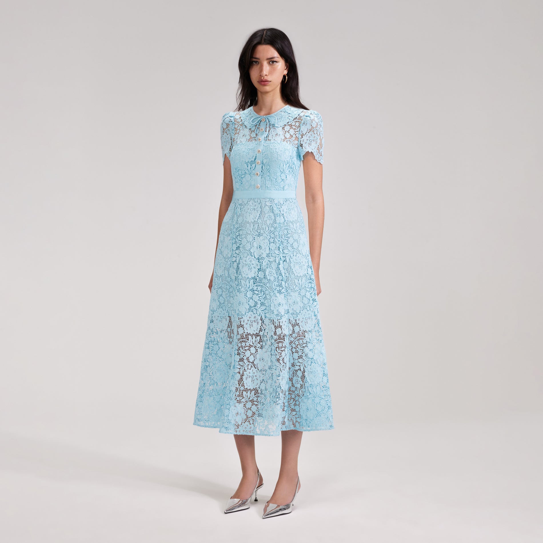 A woman wearing the Pale Blue Cord Lace Midi Dress