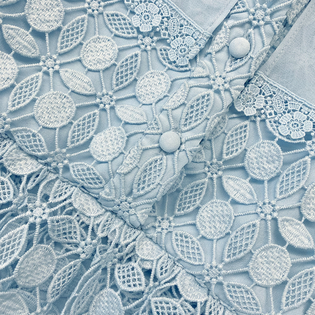 A close up of the fabric for the Blue Lace Dress With Double Collar