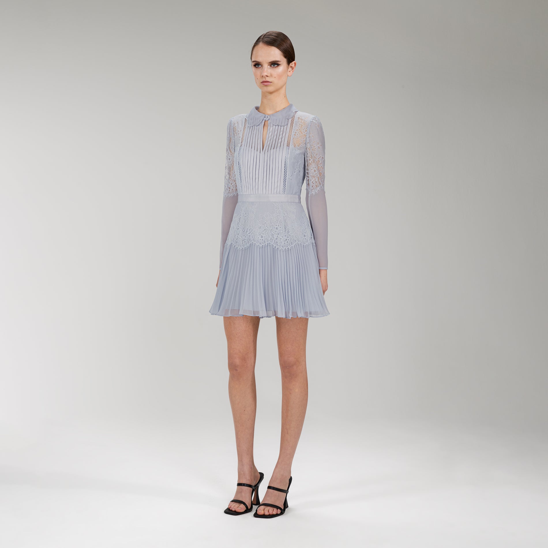 Side view of a woman wearing the Light Blue Lace Panel Mini Dress