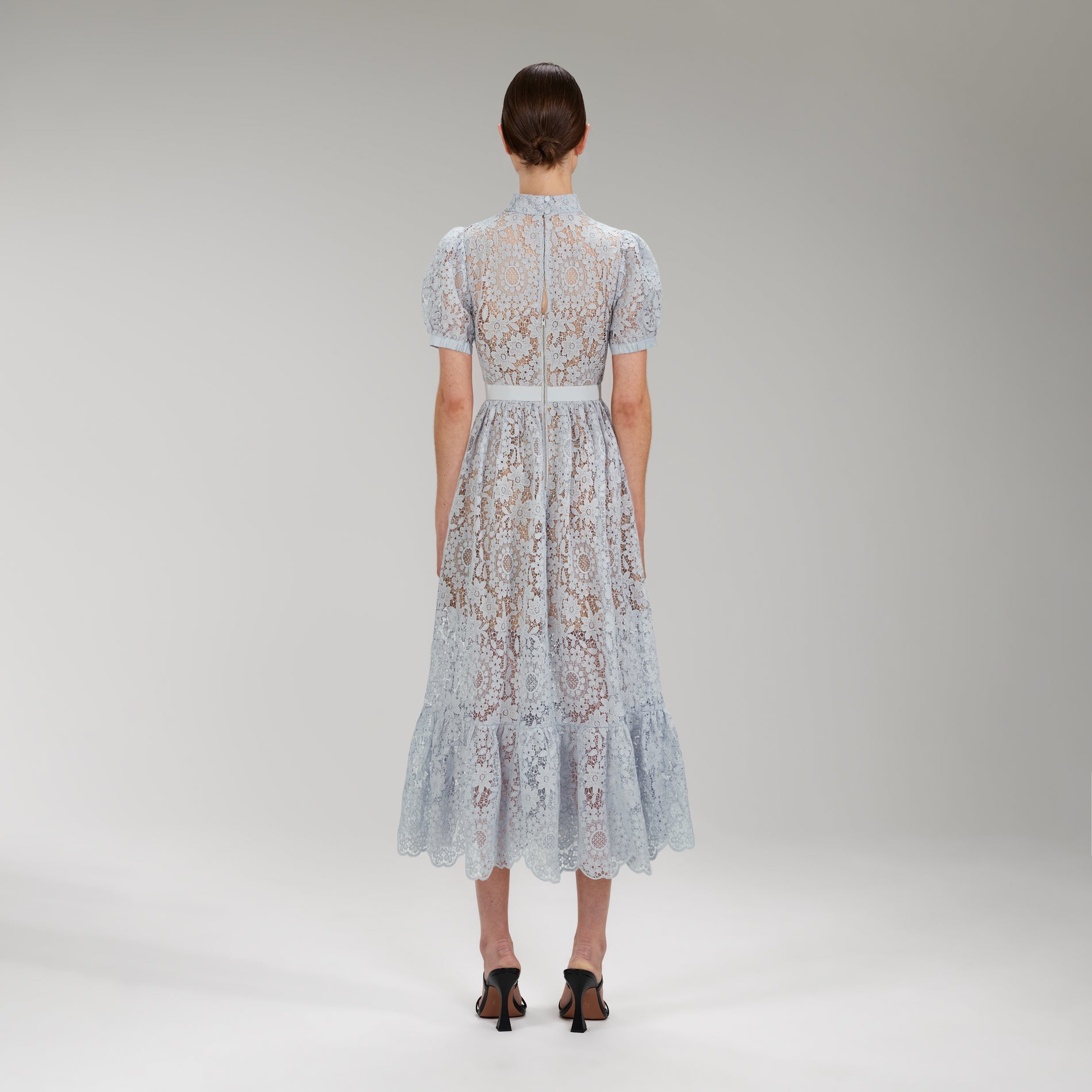 A woman wearing the Blue Guipure Lace Midi Dress