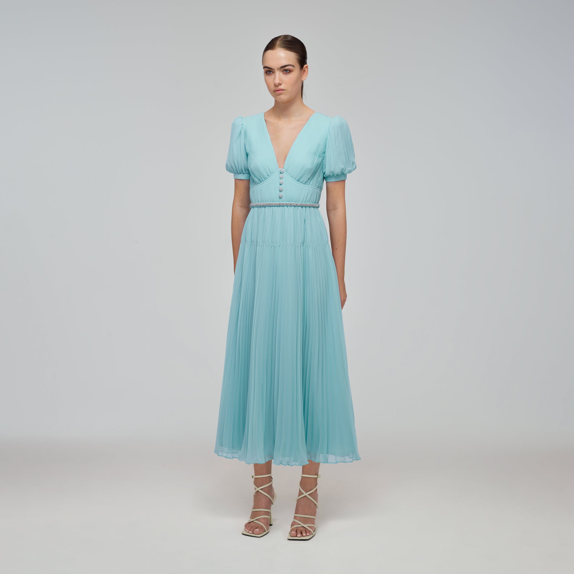 A woman wearing the Blue Chiffon Diamanté Button Midi Dress