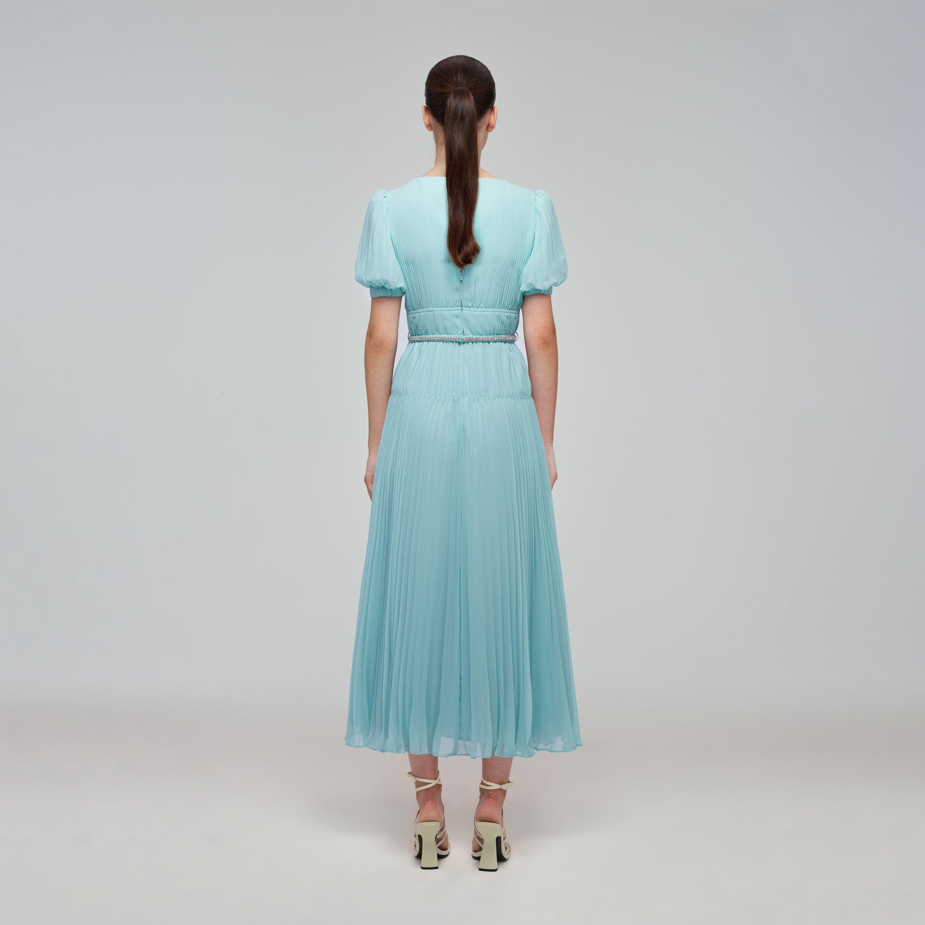 A woman wearing the Blue Chiffon Diamanté Button Midi Dress