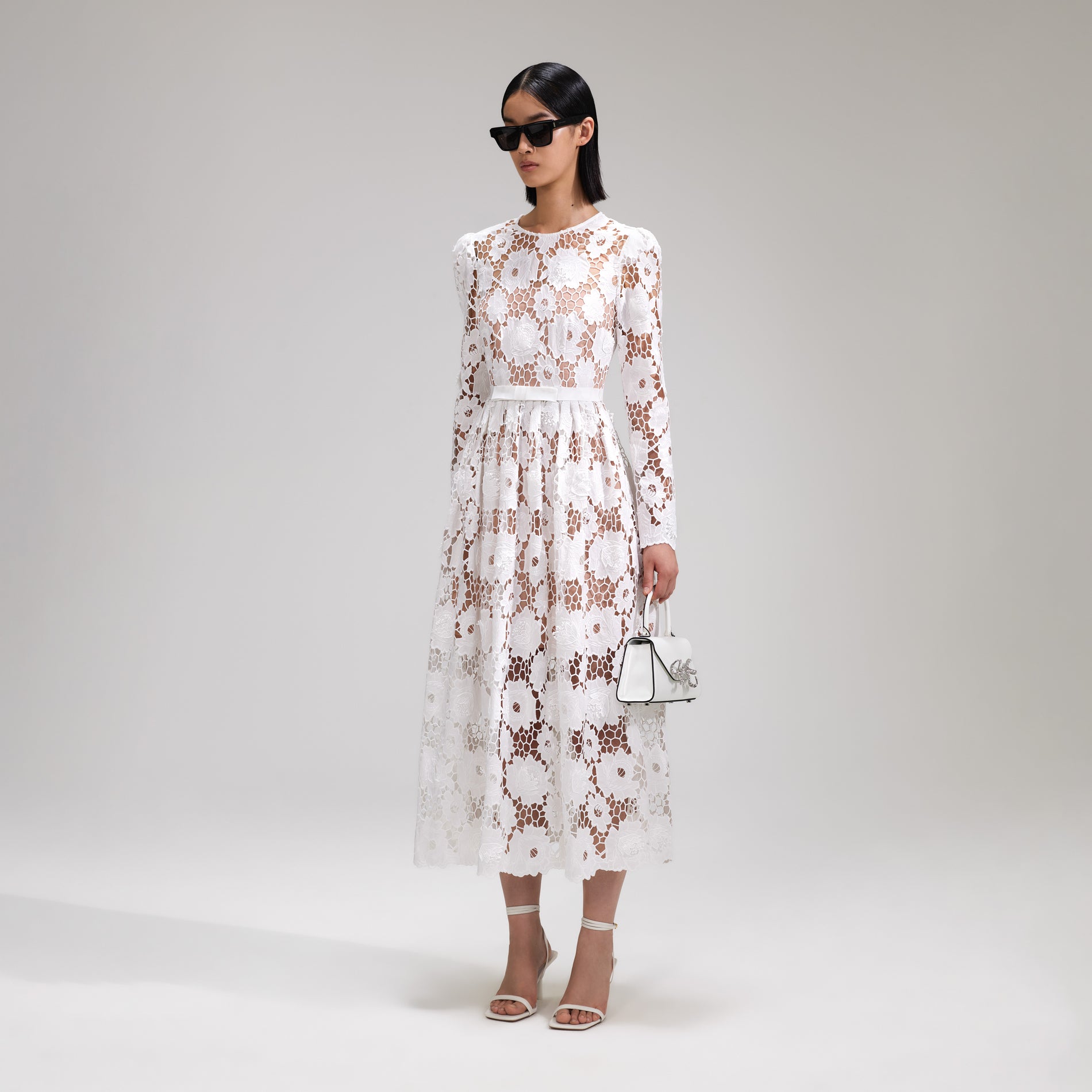 A woman wearing the White 3D Cotton Lace Midi Dress