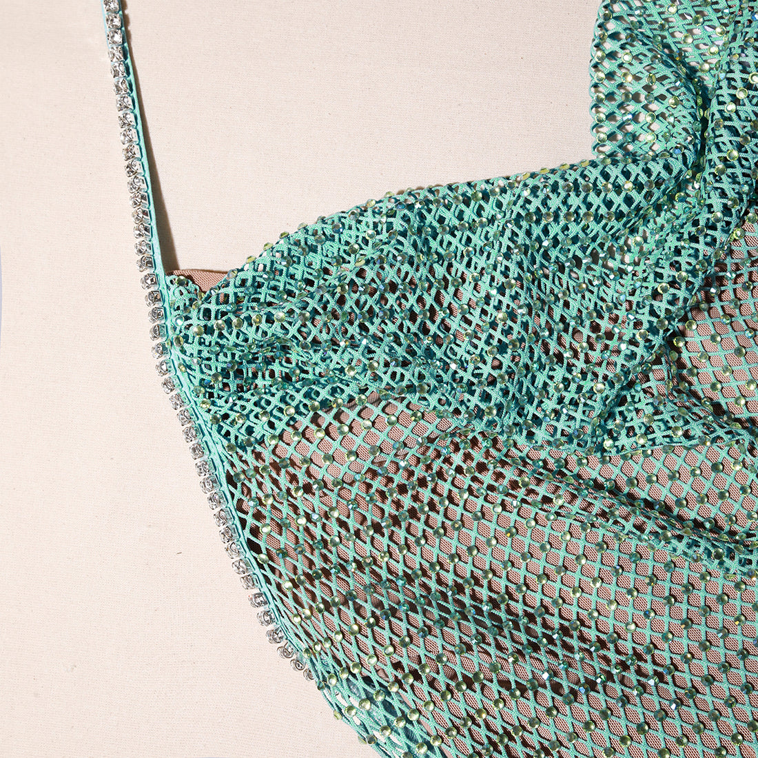 A close up of the fabric for the Mint Rhinestone Fishnet Cowl Maxi Dress