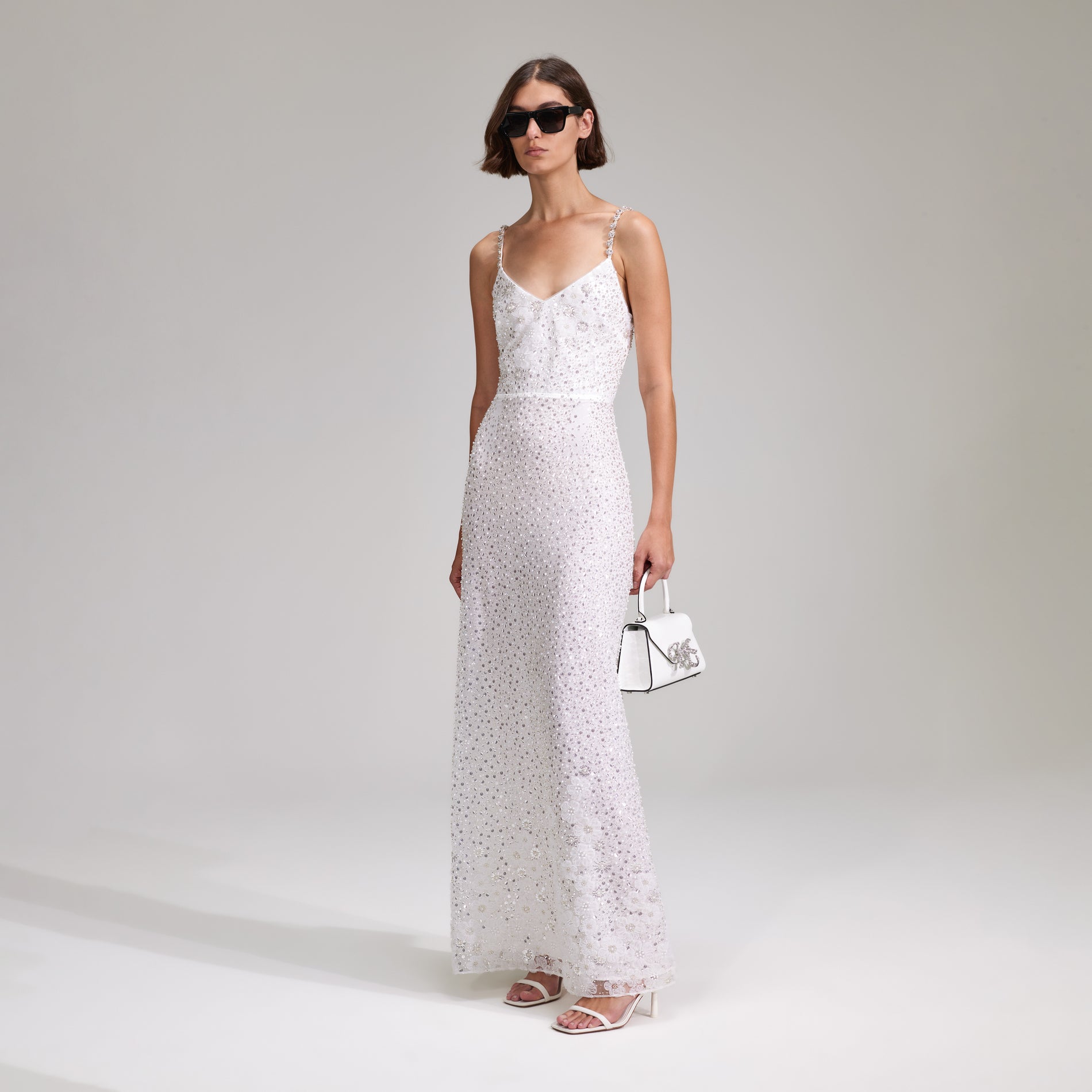 A woman wearing the White Beaded Sequin Maxi Dress