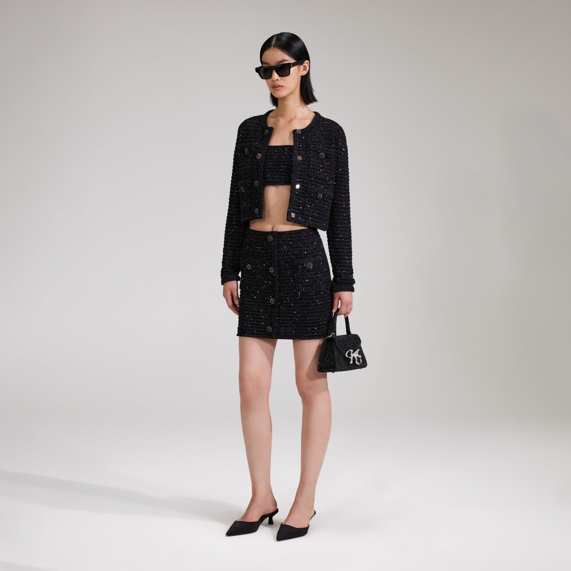A woman wearing the Black Sequin Knit Skirt