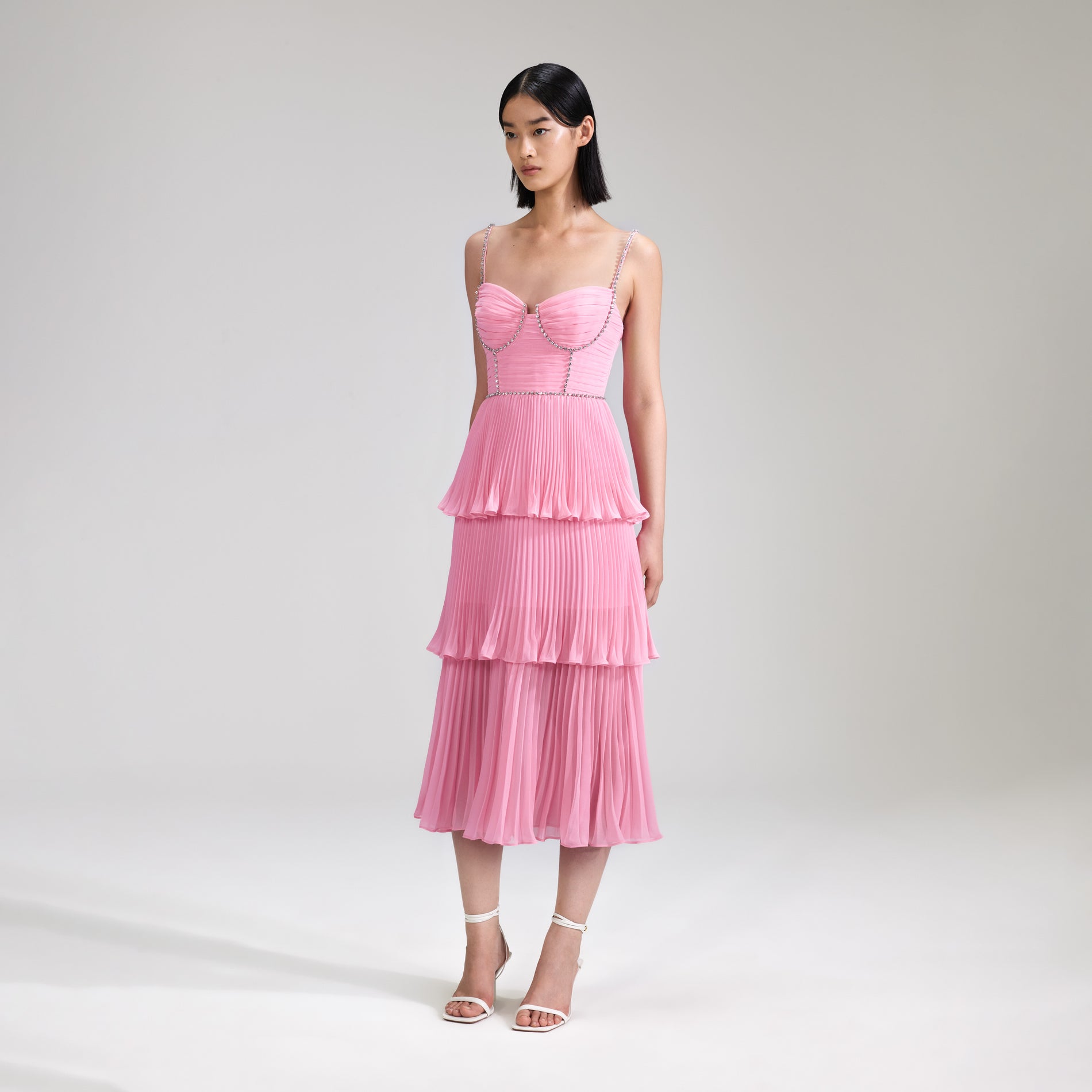 A woman wearing the Pink Chiffon Tiered Midi Dress