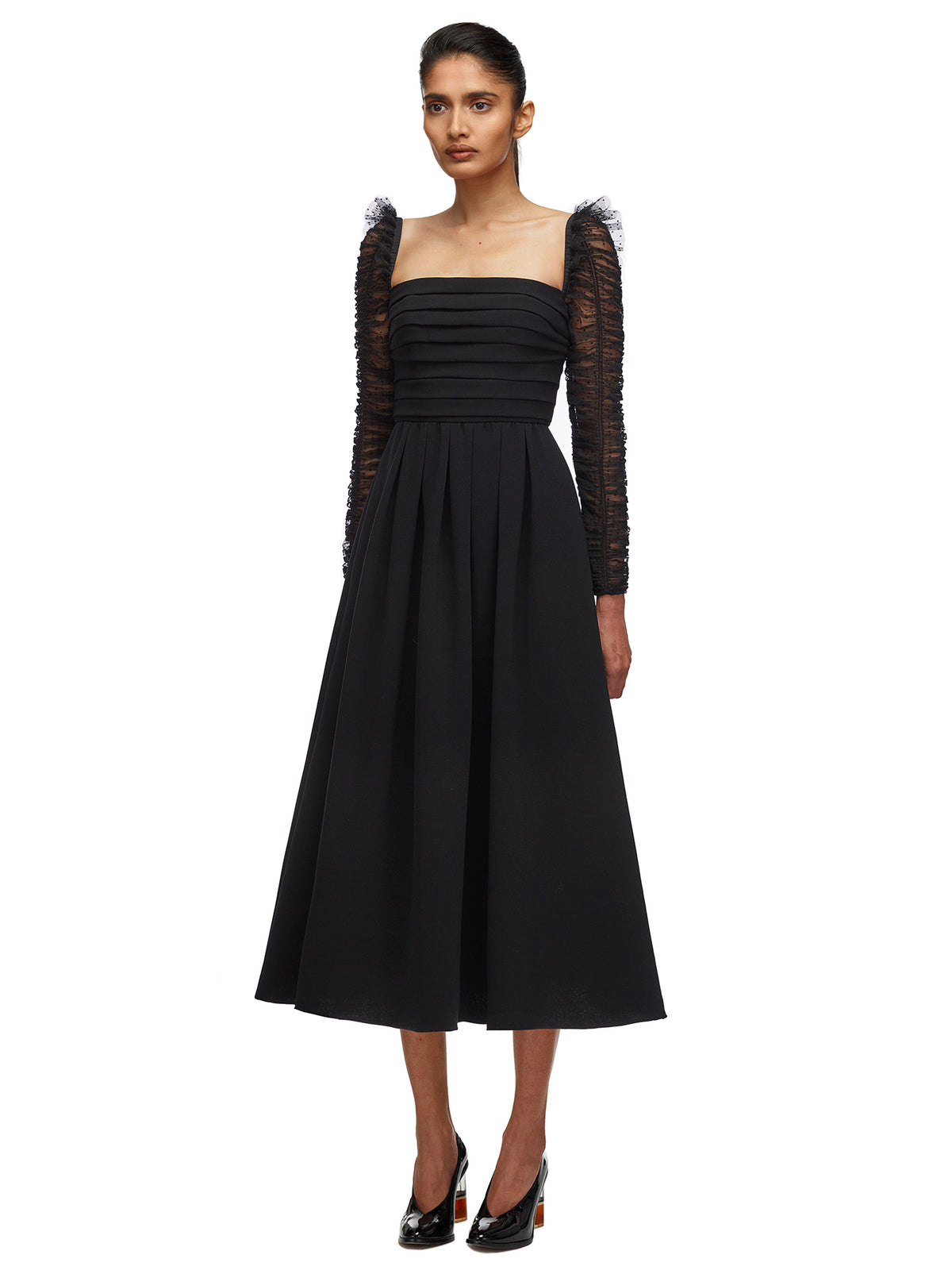 A woman wearing the Crepe Dot Mesh Sleeved Midi Dress