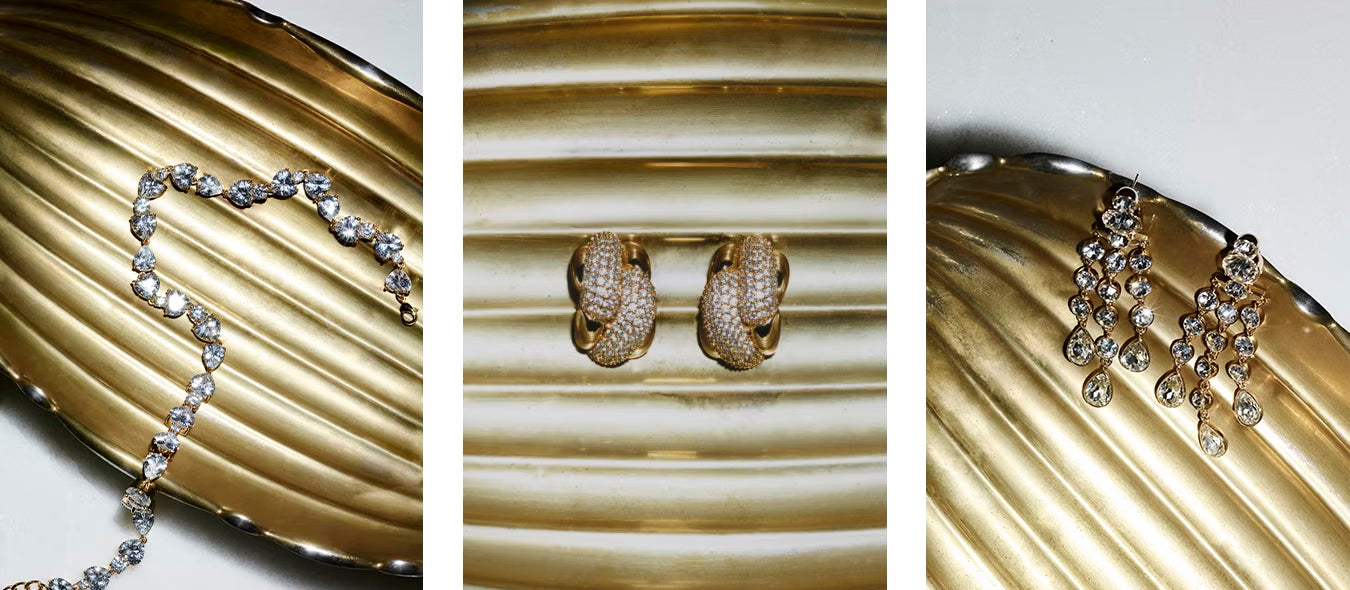 Set of gold jewellery including necklace, earrings, and bracelet on a textured gold surface.