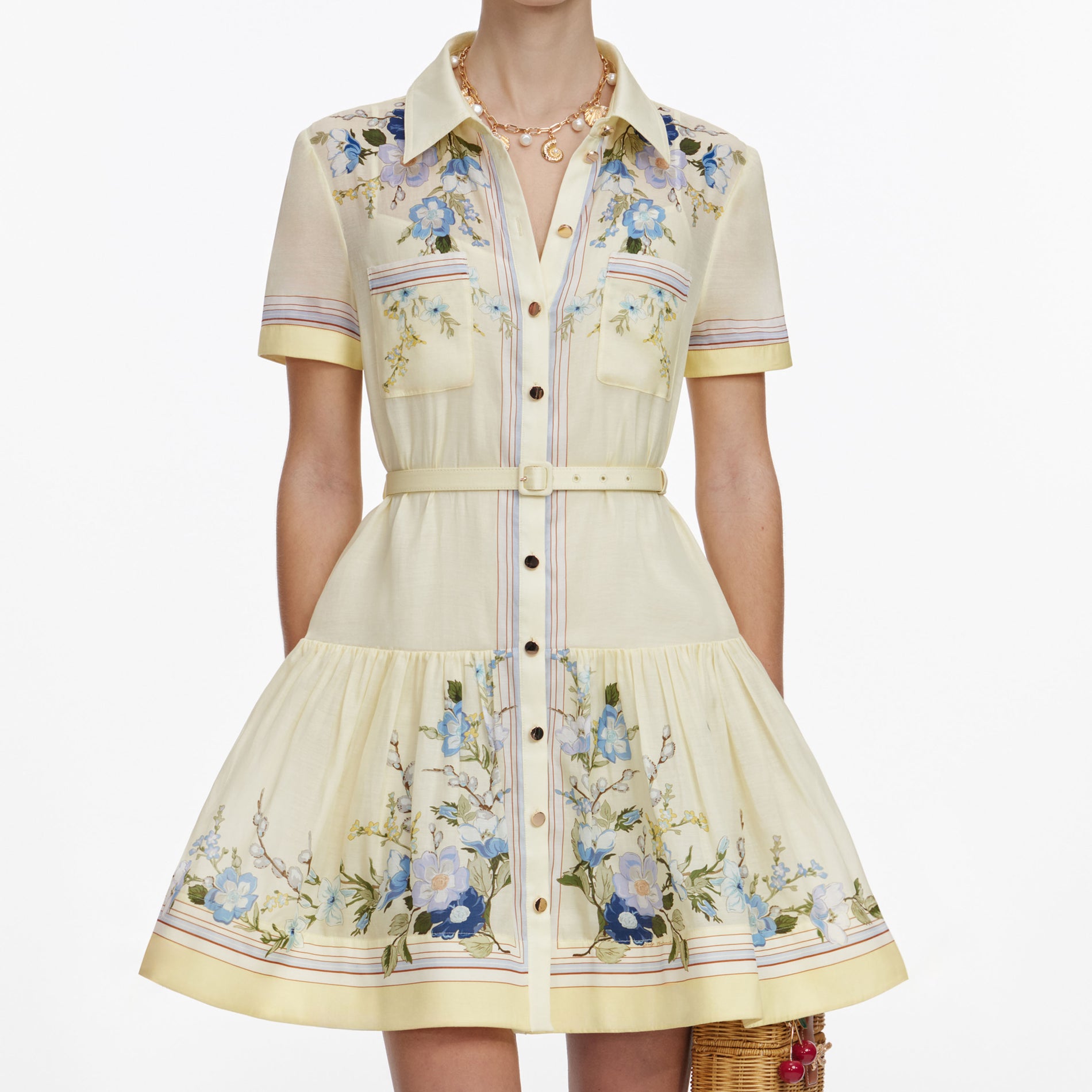 A close up of a woman wearing the Yellow Floral Organza Mini Dress