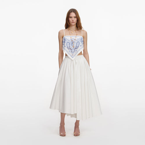 Front view of a woman wearing the White And Blue Embroidered Linen Top