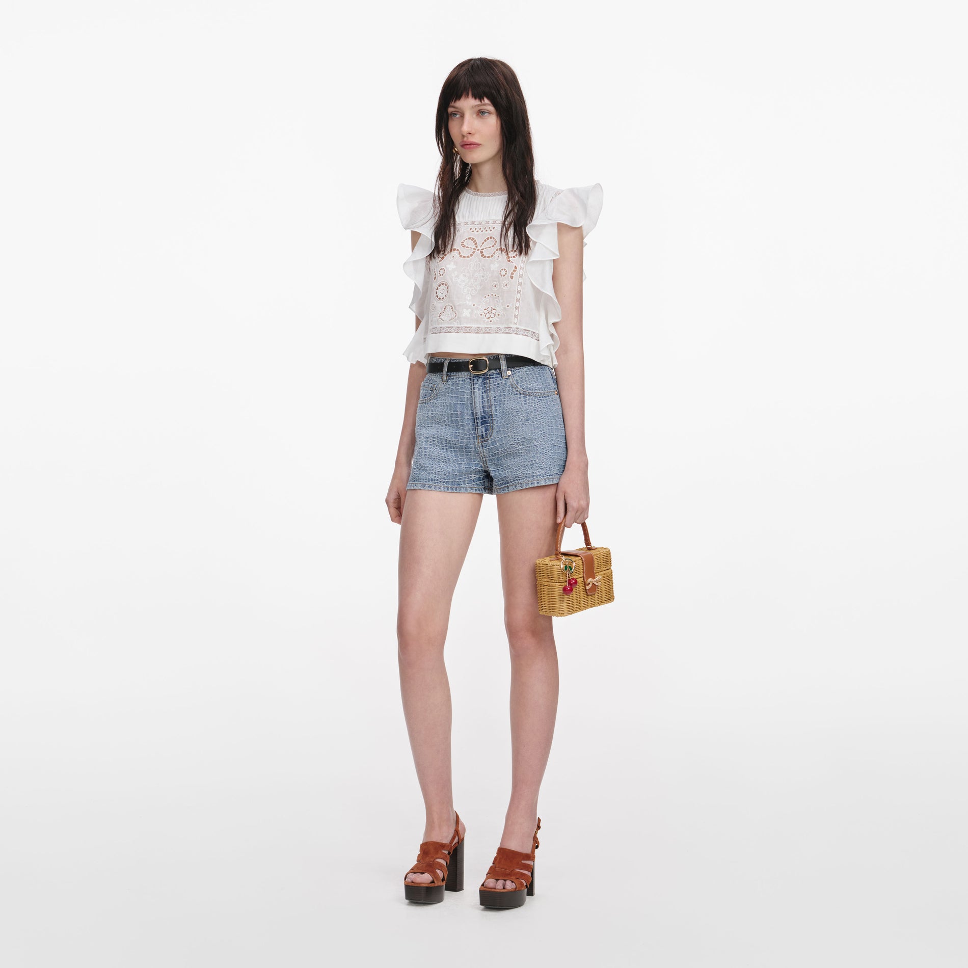 Side view of a woman wearing the White Ramie Lace Frill Top