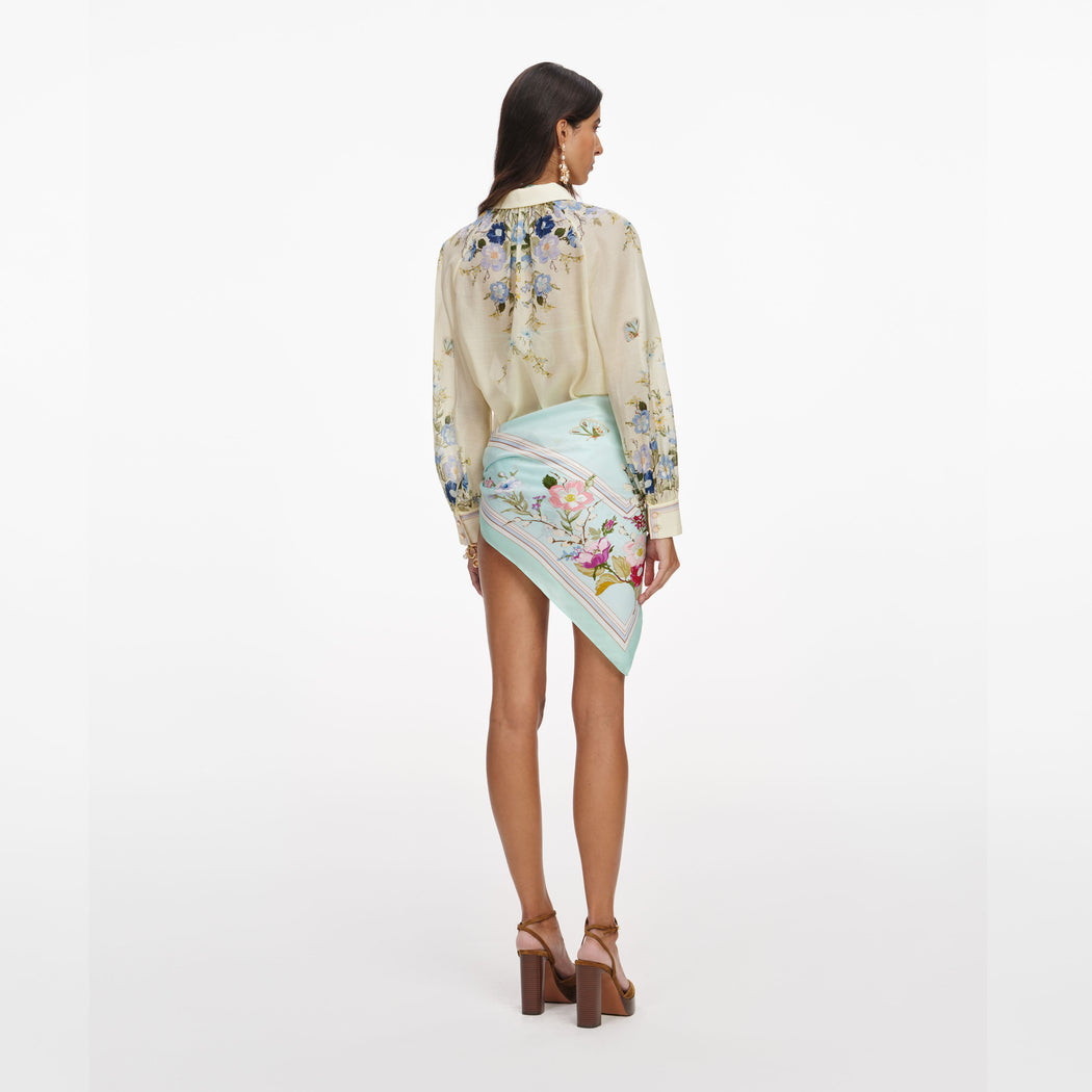 Back view of a woman wearing the Yellow Floral Organza Blouse