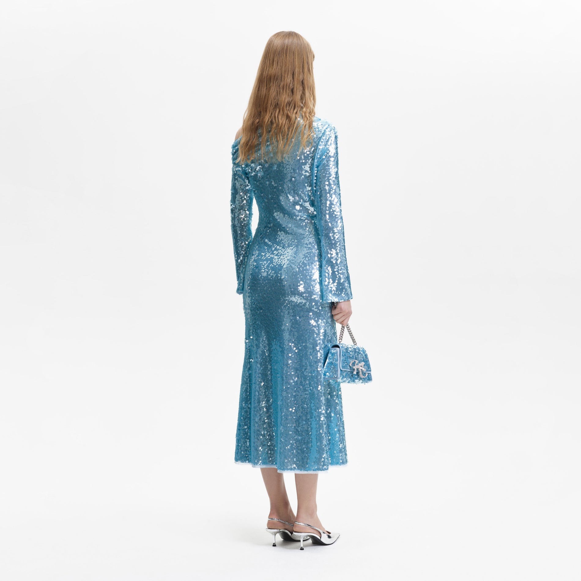 A woman wearing the Blue Sequin Asymmetric Midi Dress