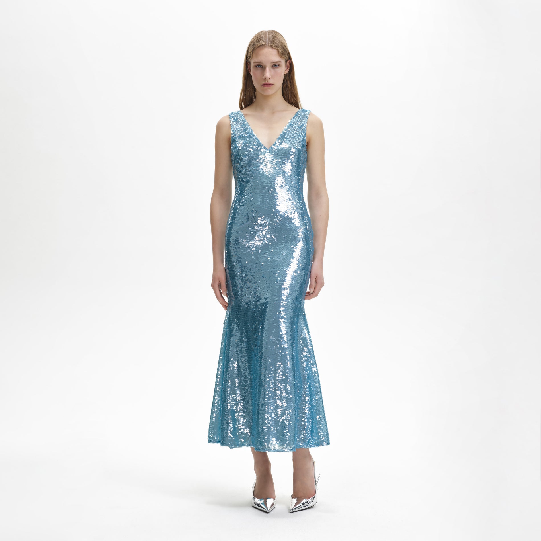 A woman wearing the Blue Sequin V Neck Maxi Dress