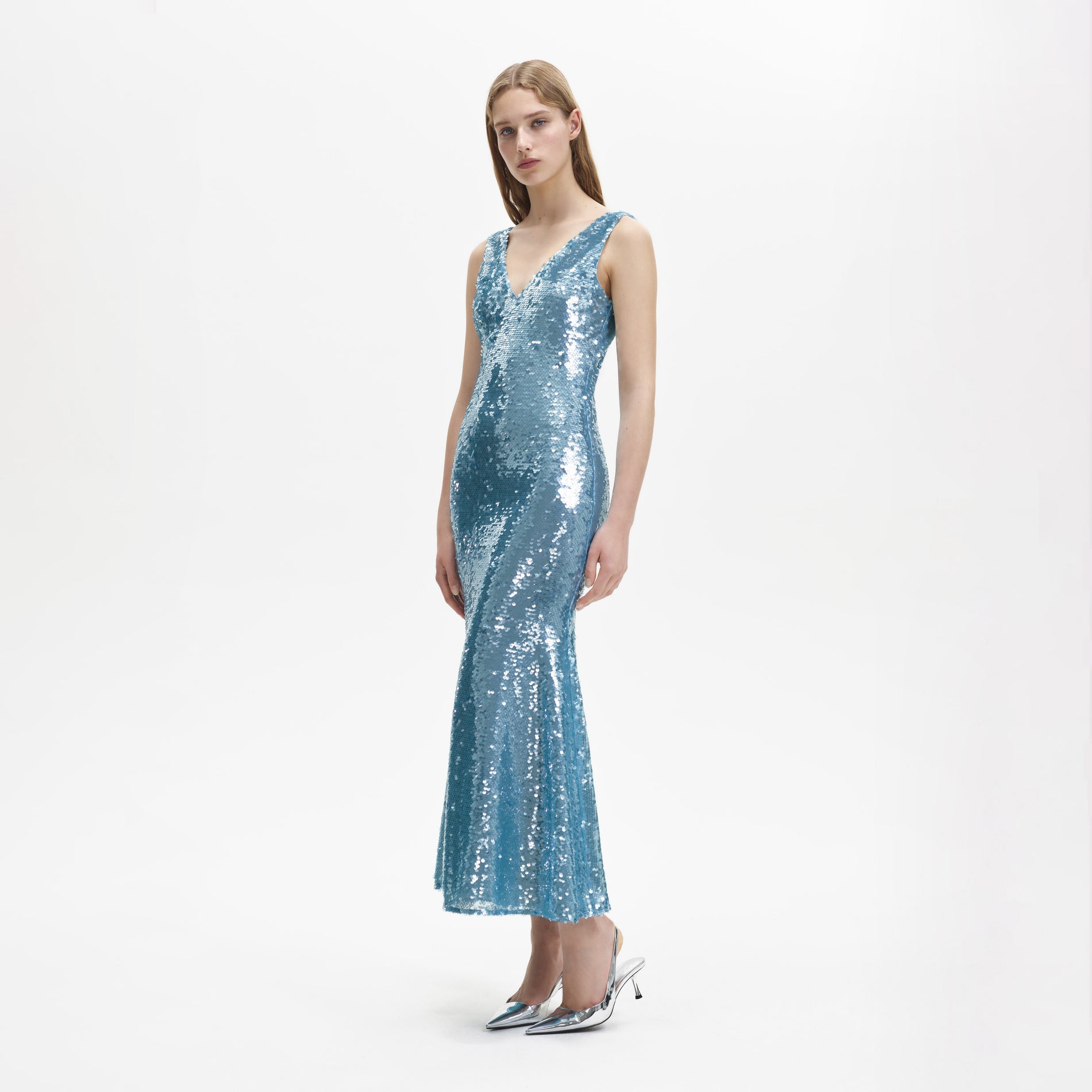 A woman wearing the Blue Sequin V Neck Maxi Dress