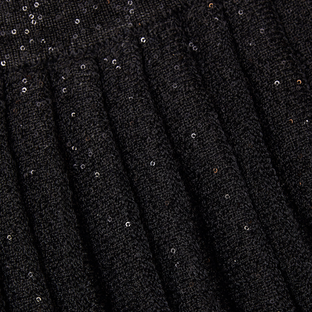 A close up of the fabric for the Black Pleated Knit Mini Skirt