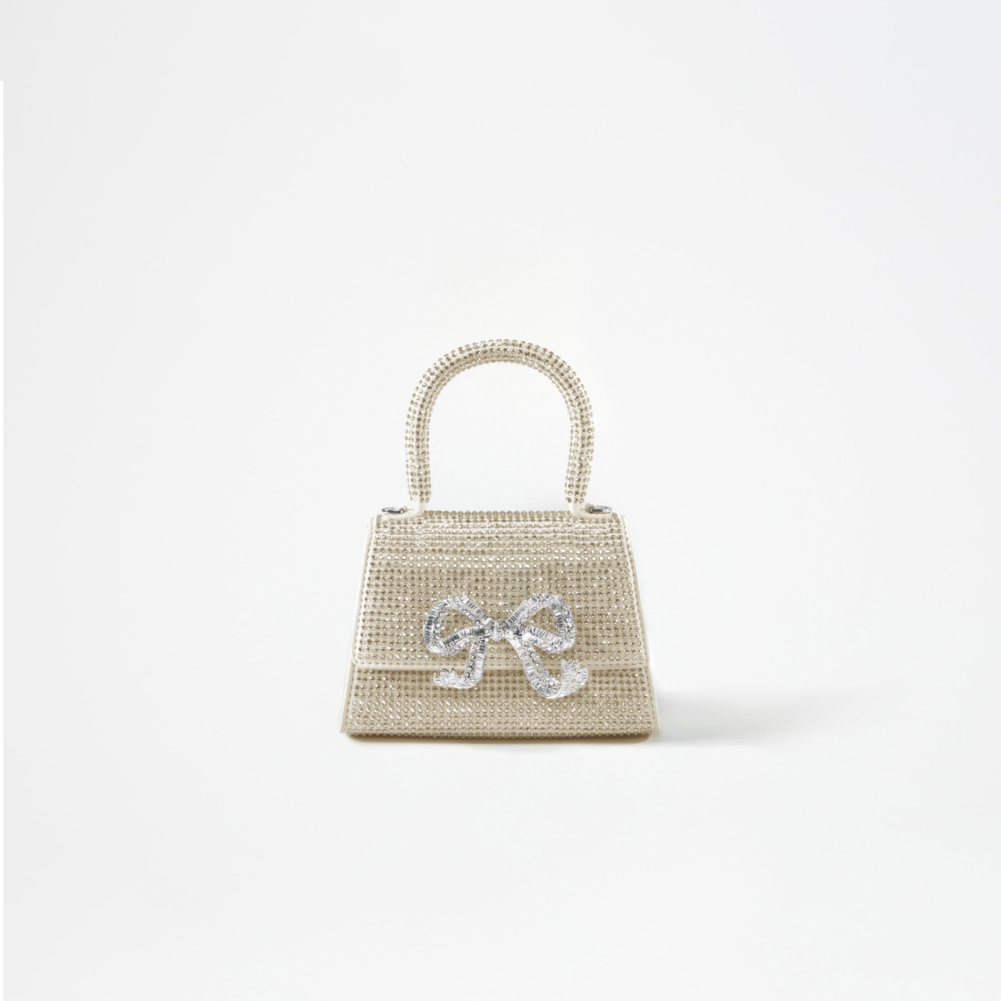 A woman wearing the Cream Rhinestone Bow Micro Bag