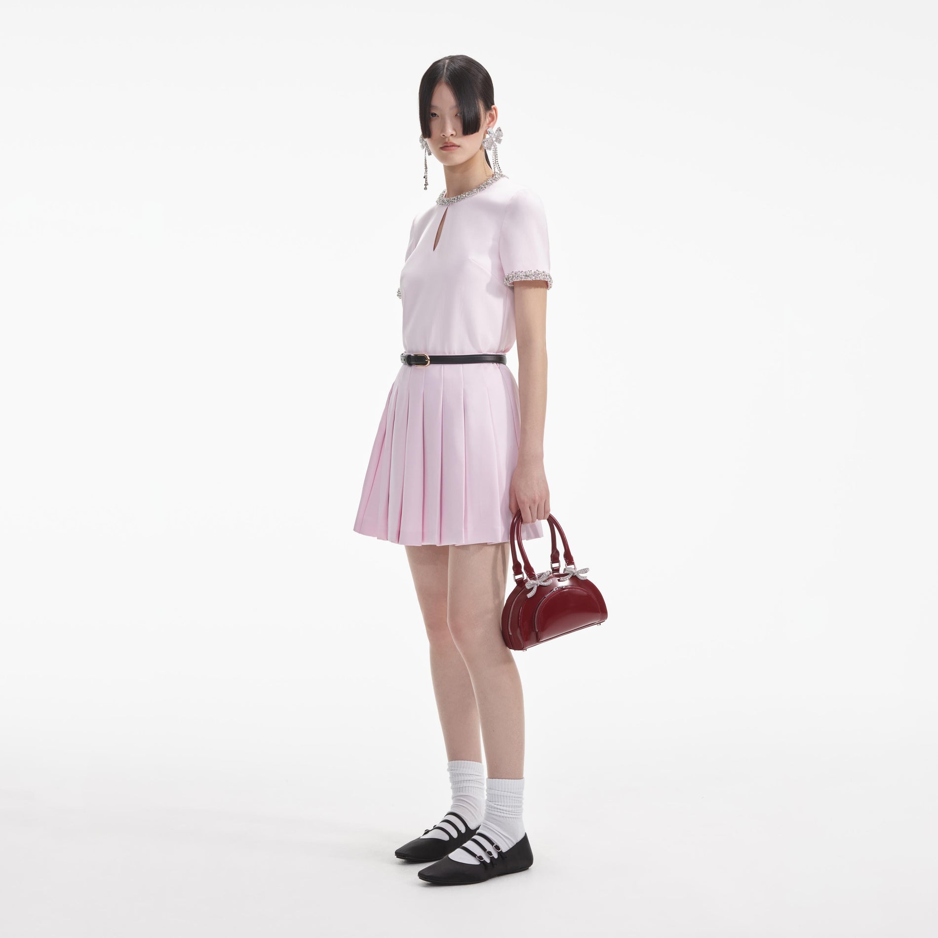 Side view of a woman wearing the Pink Satin Mini Skirt