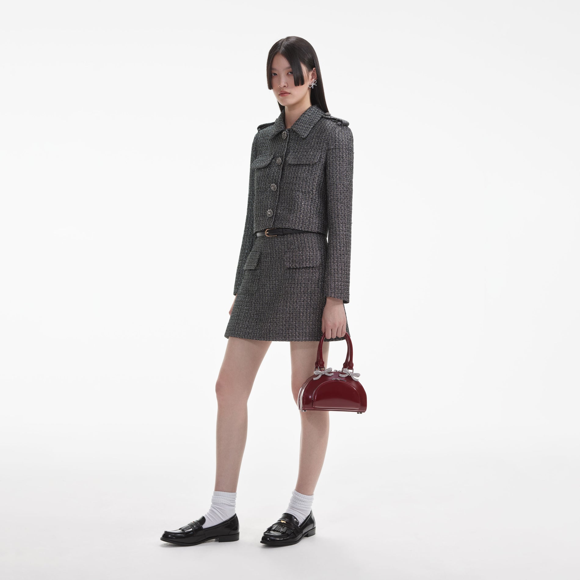 Side view of a woman wearing the Metallic Boucle Mini Skirt