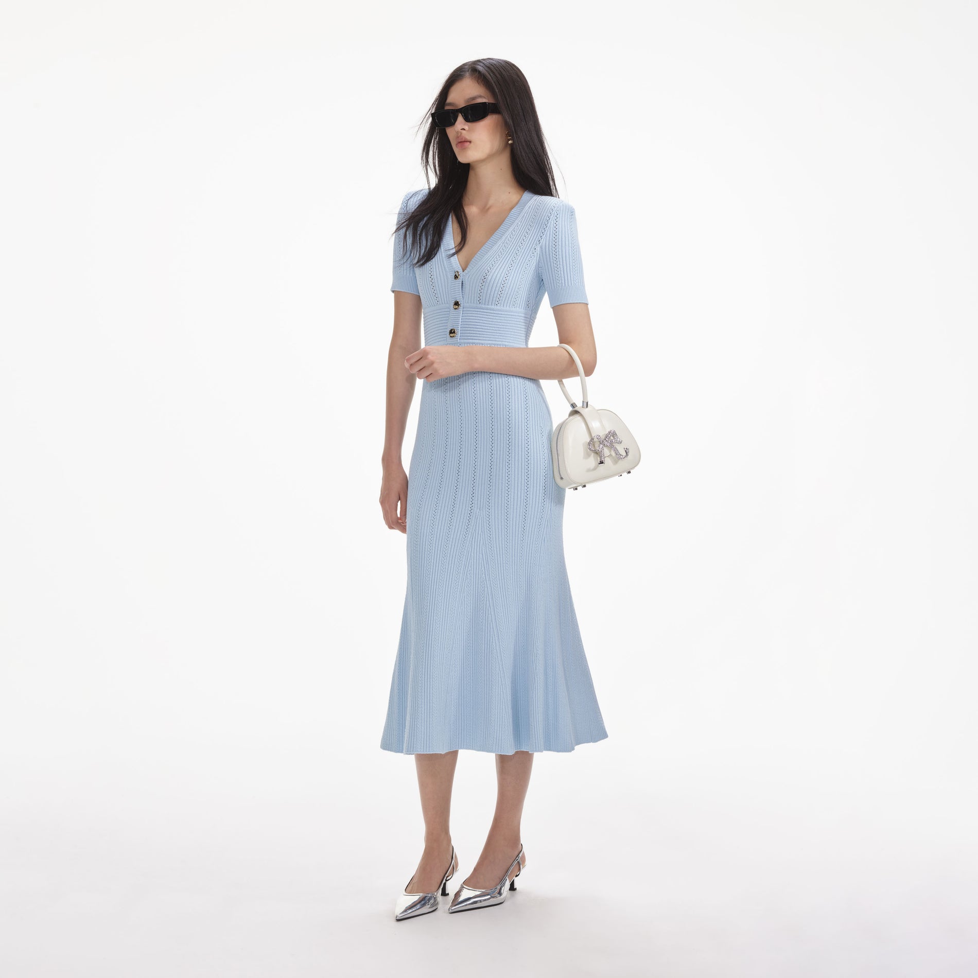 Side view of a woman wearing the Blue Pointelle Knit Midi Dress