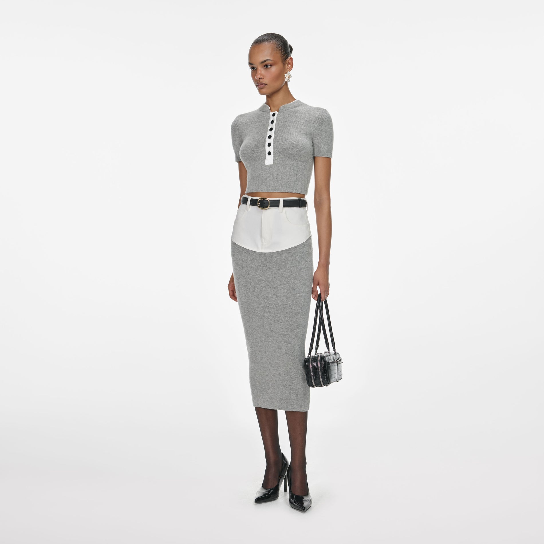 Side view of a woman wearing the Grey Knit Denim Insert Midi Skirt